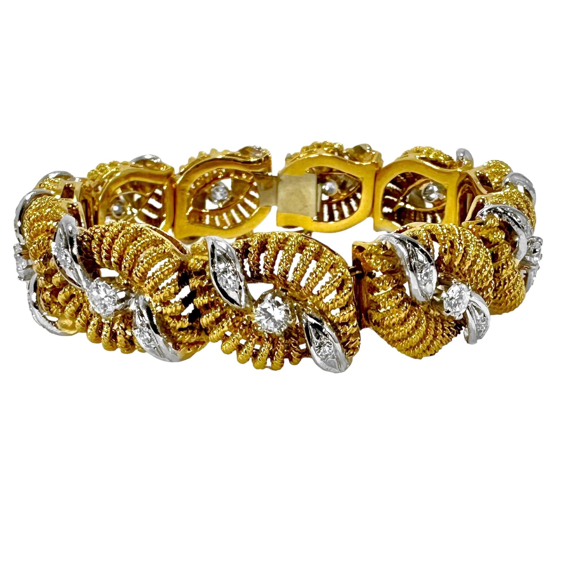 This lovely and predominantly hand crafted 18k yellow gold bracelet is clearly the product of a very sophisticated craftsman. Each link repeats organic motif hand twisted wire bombe panels affixed to casted bases, and all are accented by center