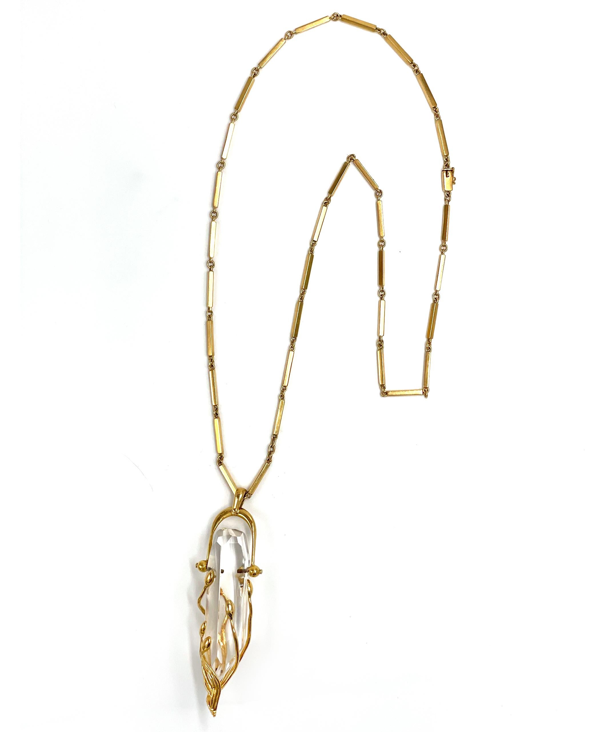 Pre owned vintage estate hand crafted 18K yellow gold quartz crystal necklace.  The unique pendant frame consists of a faceted quartz crystal measuring approximately 58x16mm.  The crystal if fitted with an ornate cap and topped with a hinged loop. 