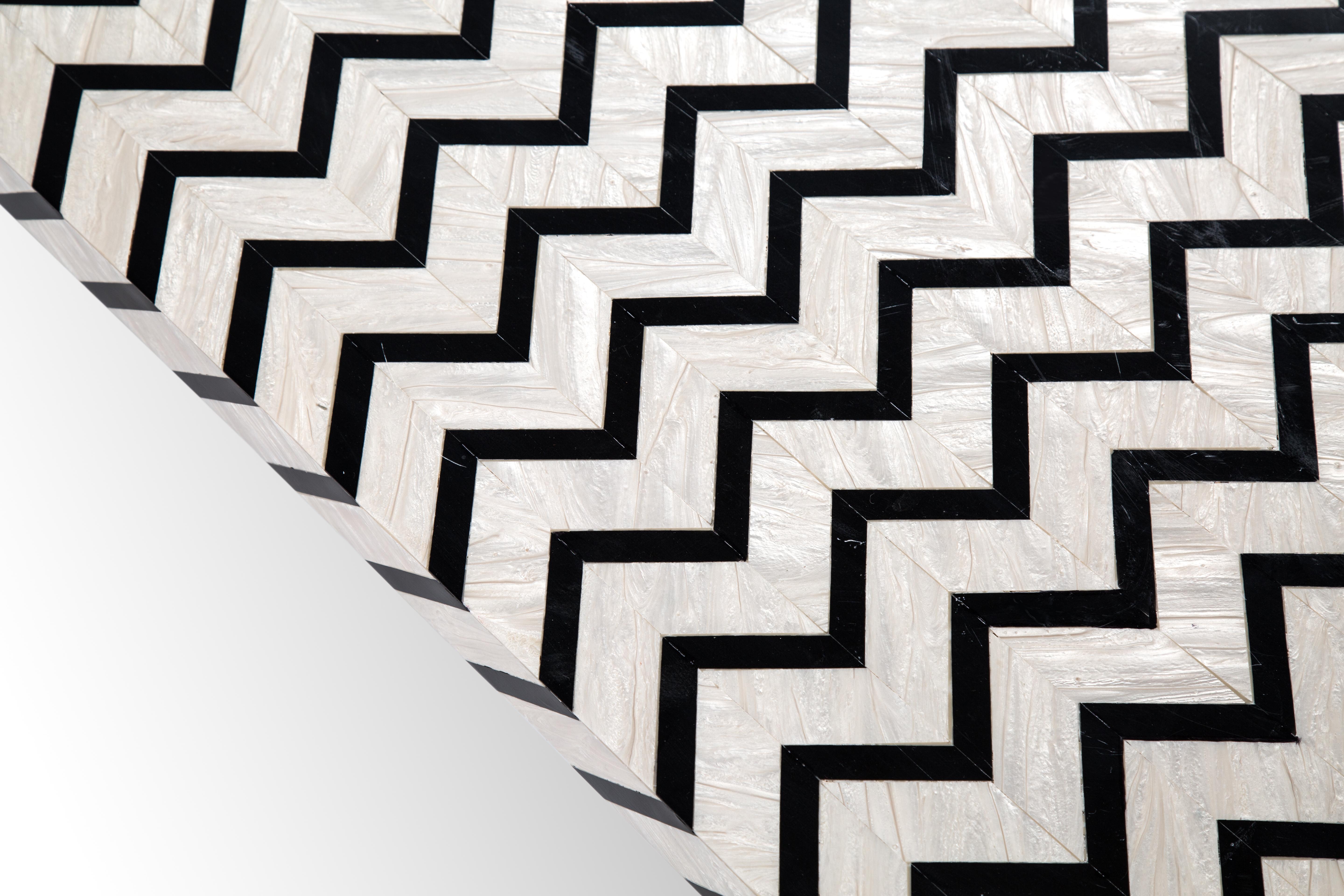 Hand Crafted Acrylic Coffee Table with Nile Pattern Inspired from Ancient Egypt.
Our Nile table adds boldness to your room with its black & white chevron pattern, which embodies the Nile’s flowing water. It is made of pearly white and black acrylic