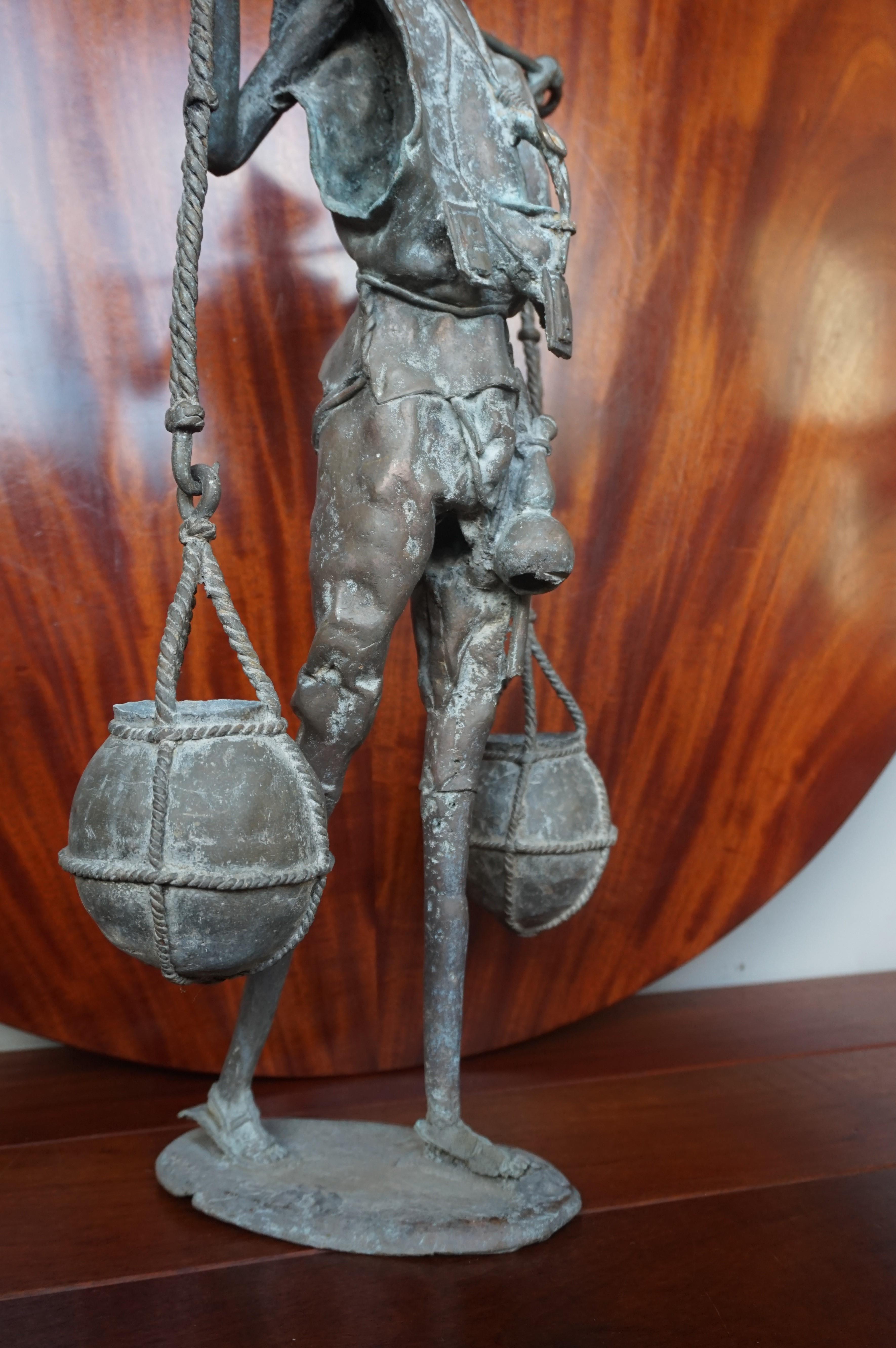 Cast Handcrafted and Wonderful Tall African Male Water Carrier Bronze Sculpture For Sale