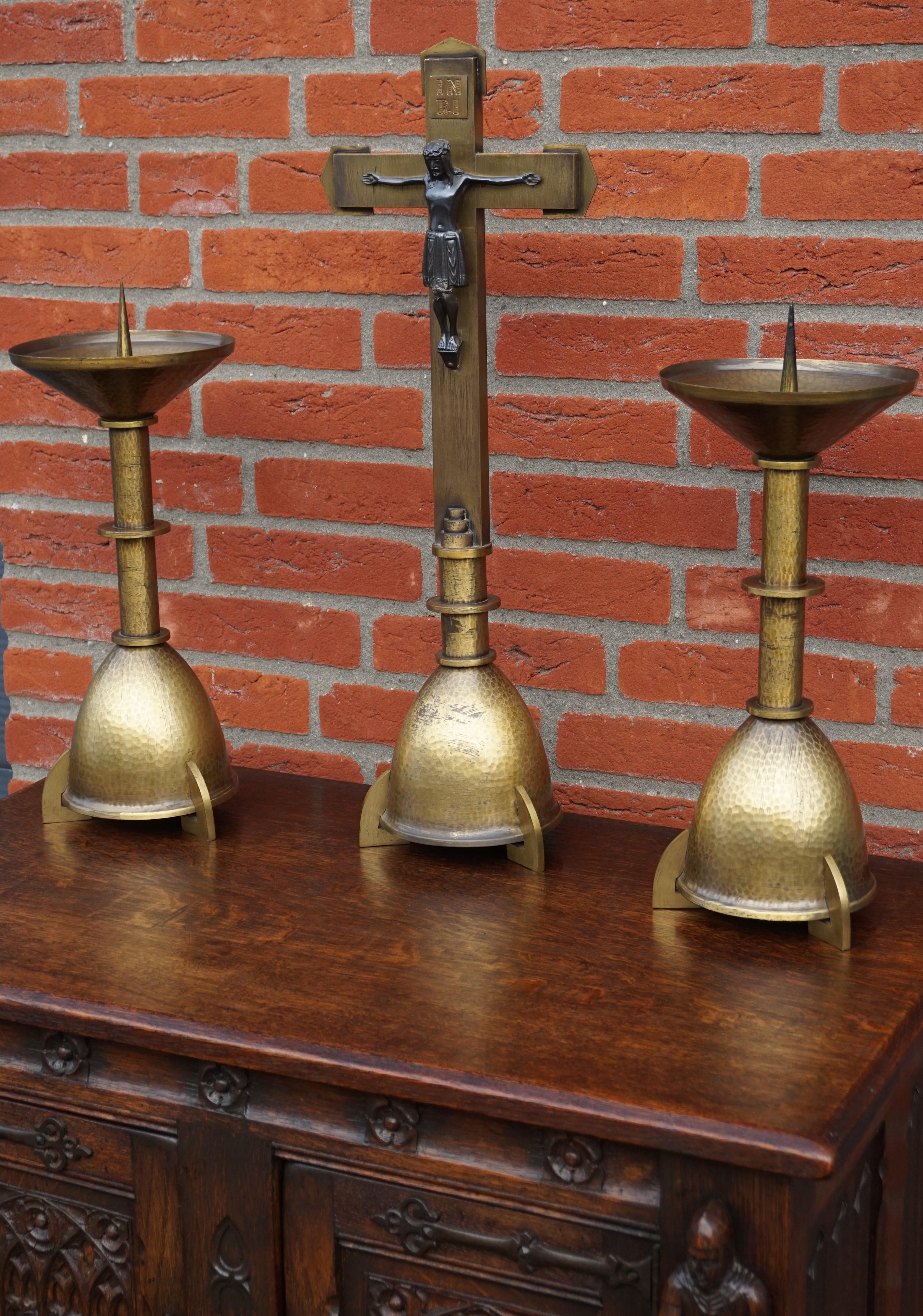 Stylish antique brass altar set with a bronzed corpus of Christ.

This beautifully designed AND very well executed, medieval style altar set is all handcrafted in the European Arts and Crafts era. The perfectly identical and very aesthetically