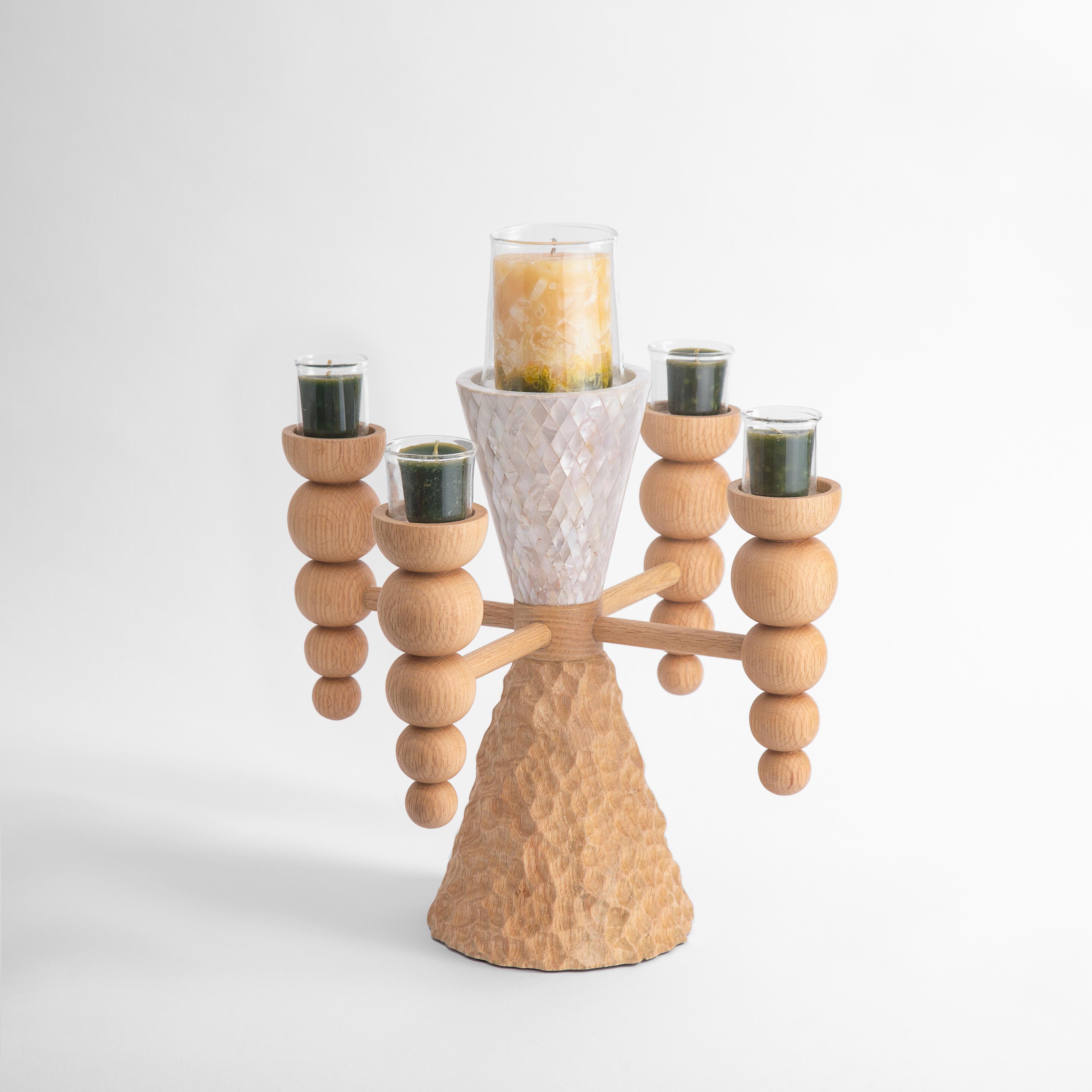Chandelier artisanal en nacre véritable et en bois de chêne massif.
Avec son cœur en forme de tornade tournoyante, ce candélabre incarne les vents du changement et l'espoir qu'ils apportent. Destiné à apporter de la joie et de la lumière à votre