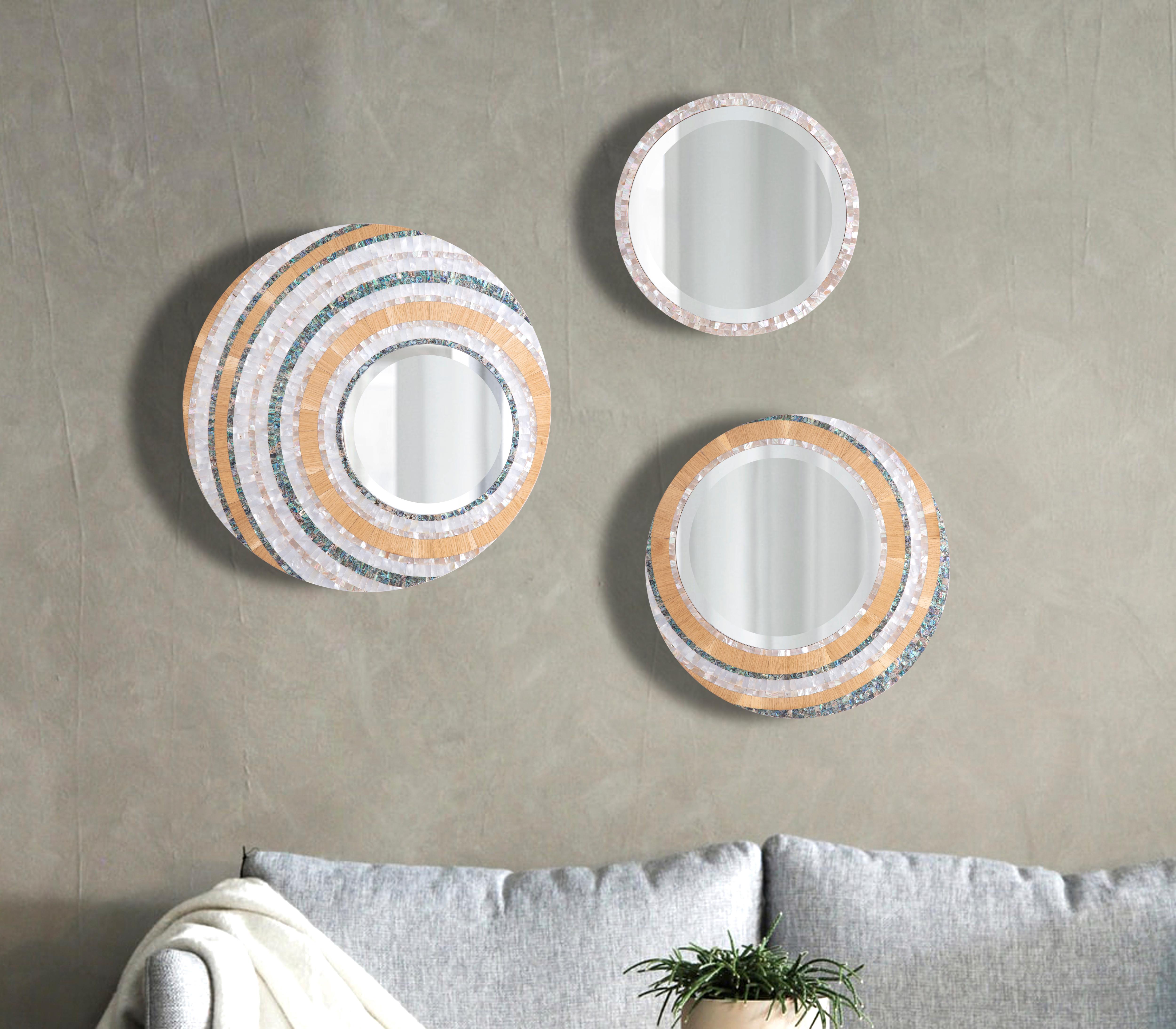 Hand-crafted decorative mirror with three colors of genuine mother-of-pearl - large.
Just like the sun, this trio of mirrors brings rays of warmth and joy to any space. They are intricately designed with three colors of genuine mother-of-pearl and