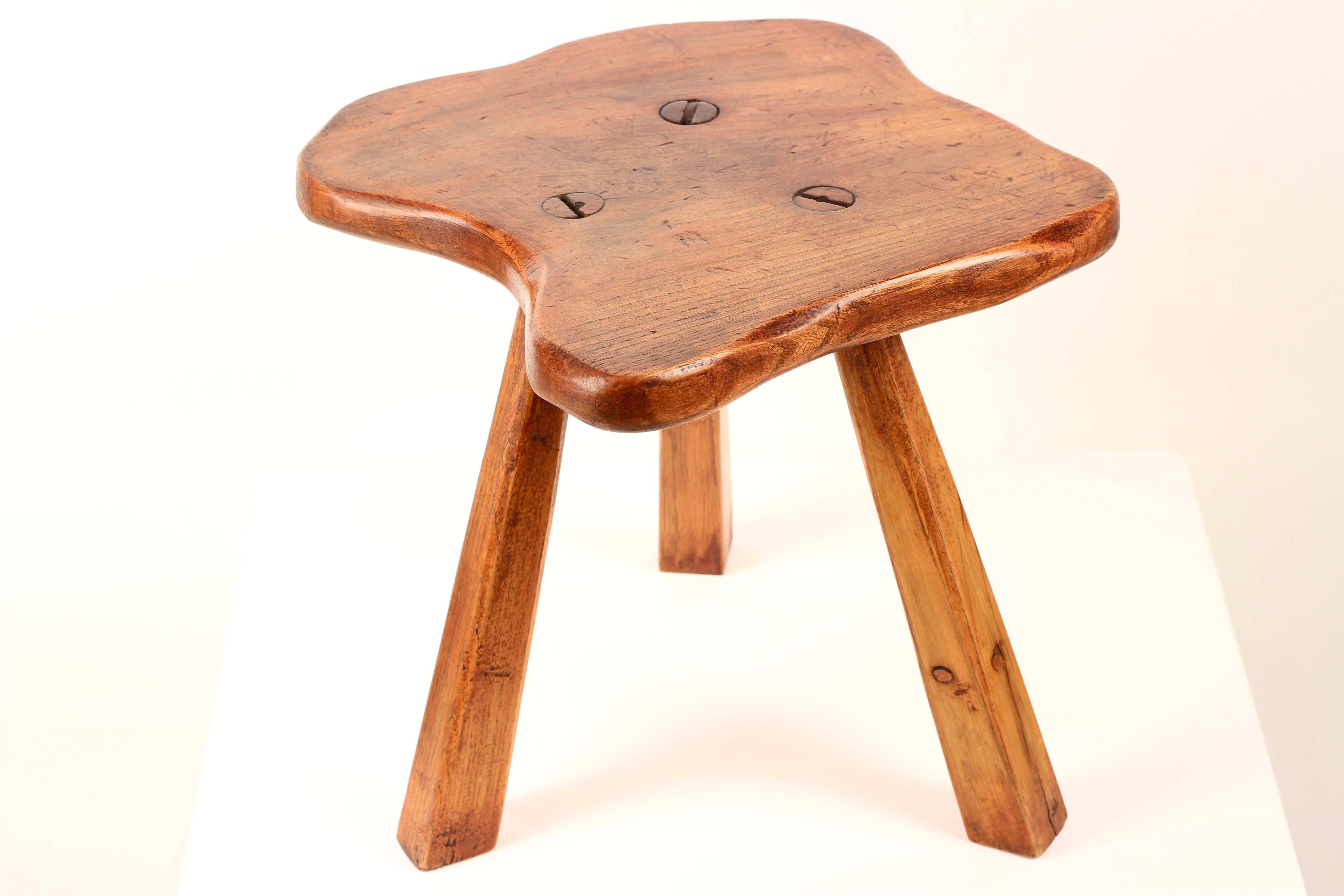 Hand-Crafted Folk Art Primitive Elm Stool  Sculptural Rustic Form

This charming primitive stool embodies the honest beauty of hand-crafted English folk art. Made in England from solid elm wood, a traditional choice for its durability and richly