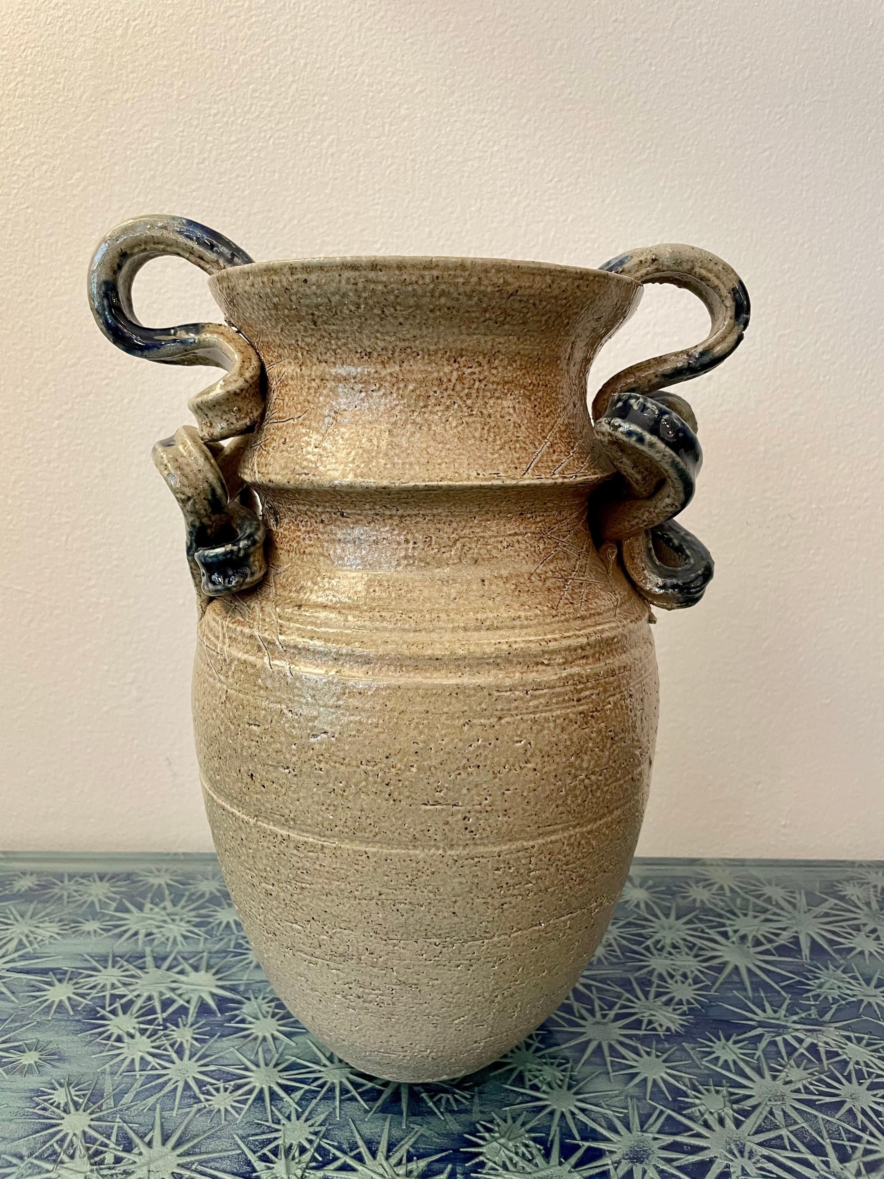 This has the most wonderful handles in flowing ribbons of blue glazed ceramic and the textured natural finish of pottery on base.