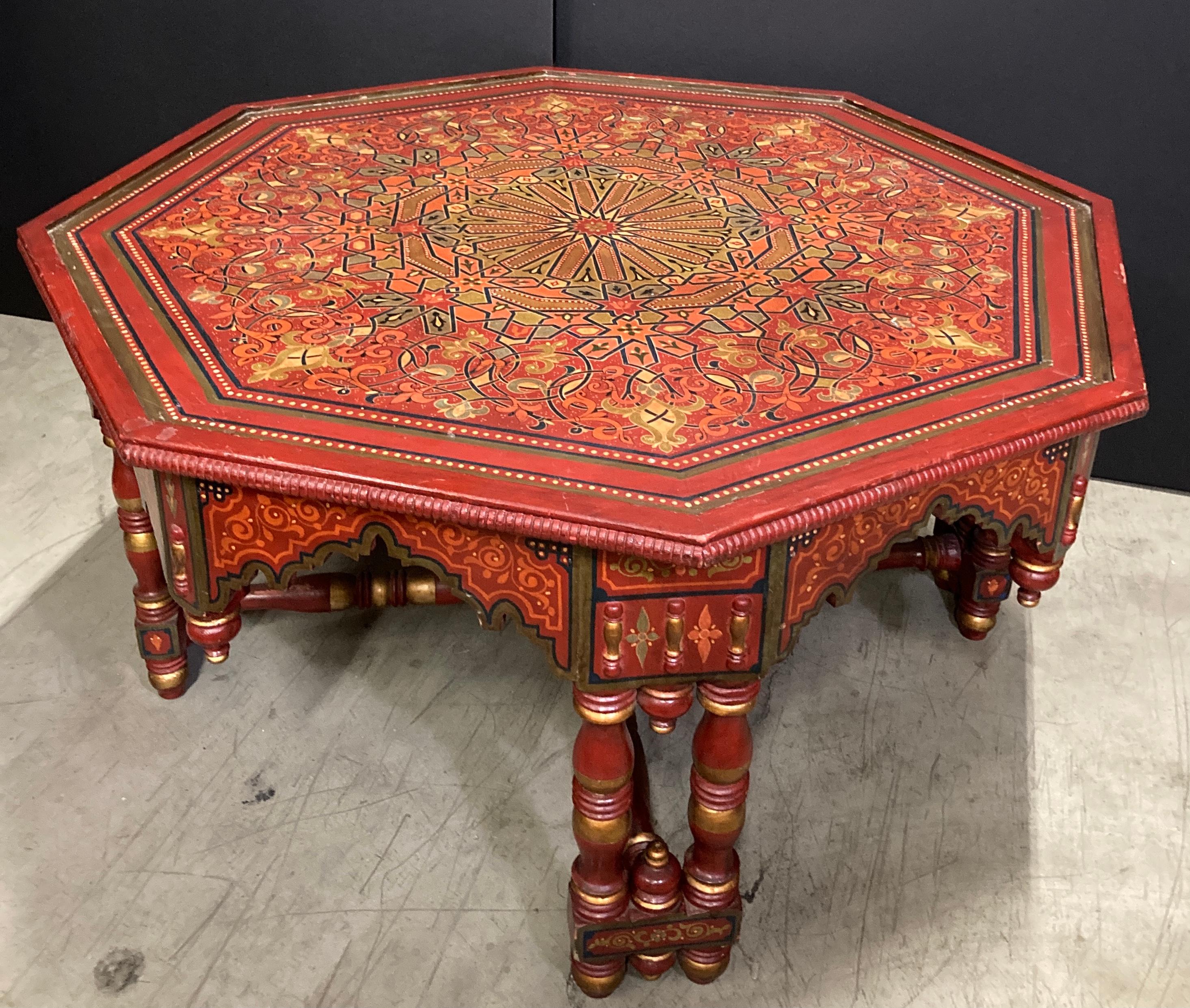 Handcrafted, hand-painted red gorgeous Moroccan coffee table. 
Polychrome octagonal wooden table with carved Moorish arches cut-out, intricate floral and geometric hand-painted design. 
Custom-made Moorish table, one of a kind handcrafted by skilled