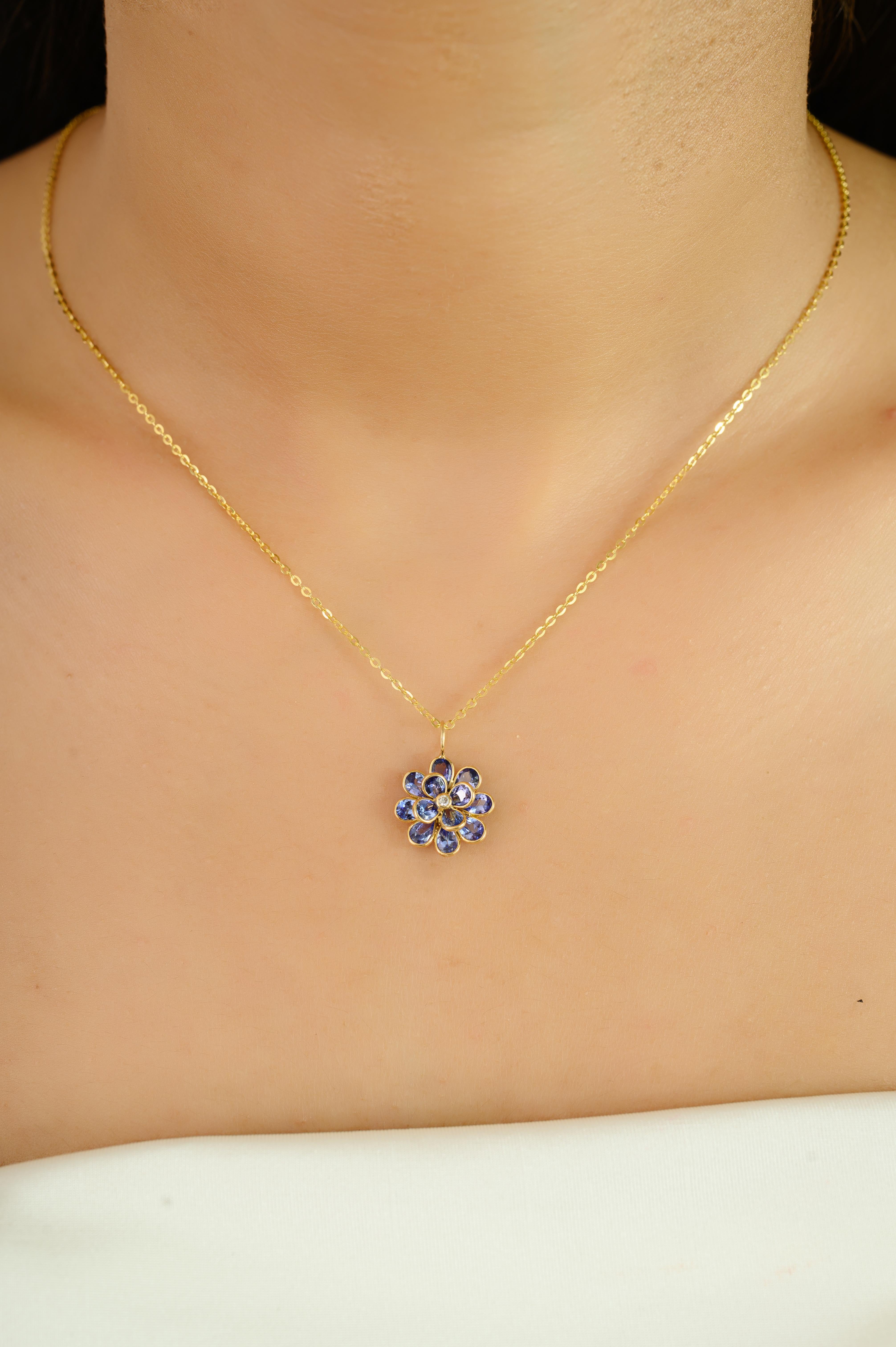 A stunning celebration of color and craftsmanship, this floral pendant is delicately handcrafted in luxurious 18k yellow gold. Featuring 2.05 carats of beautifully faceted tanzanite stones arranged in a radiant flower motif, each petal shimmers with