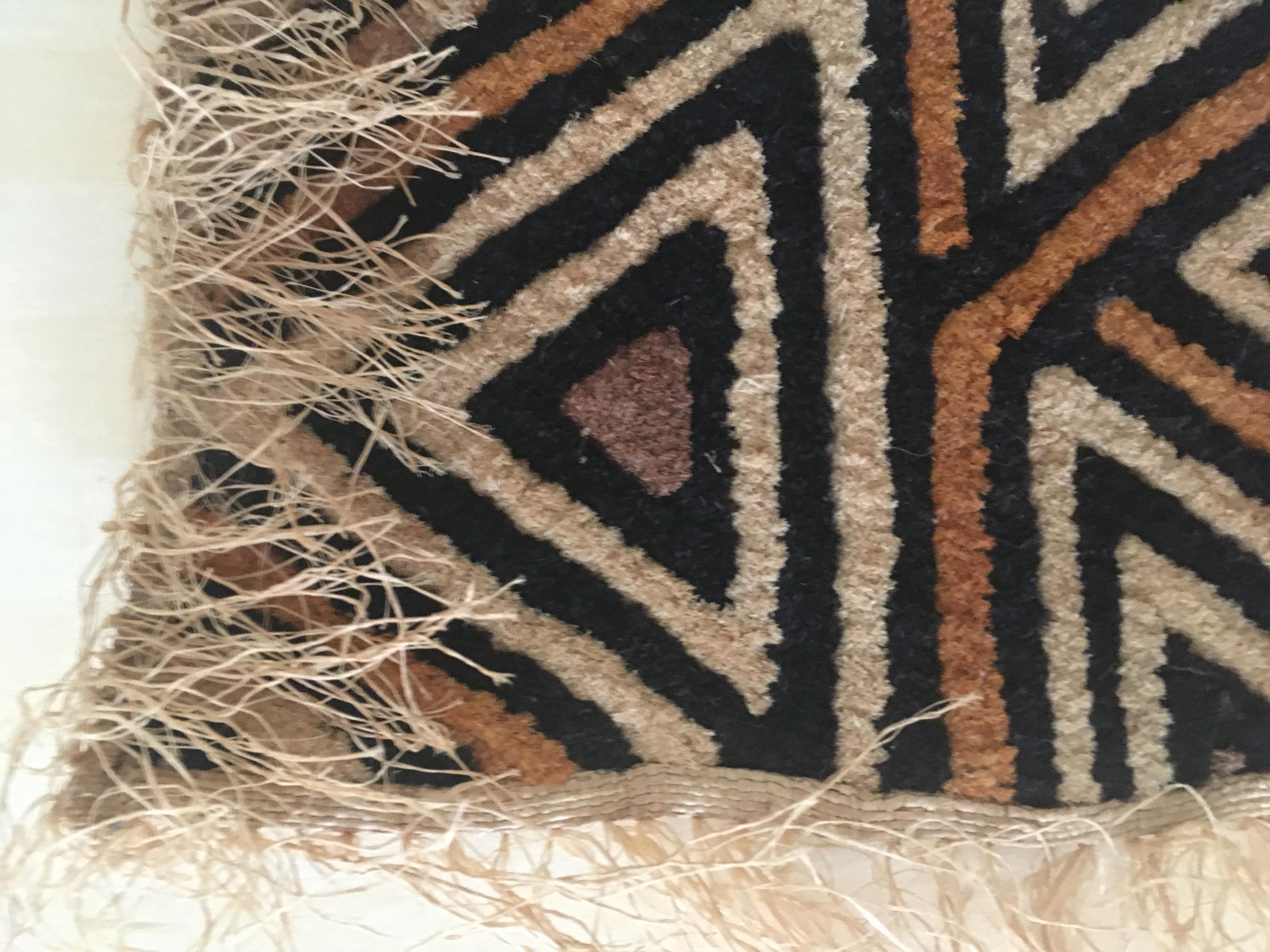 The Kuba cloth (velours du kasai) is a captivating piece of textile art hailing from the Kasai Region in the Democratic Republic of the Congo. Crafted by hand in the 1960s, this Kuba cloth wall hanging is a testament to the rich cultural heritage