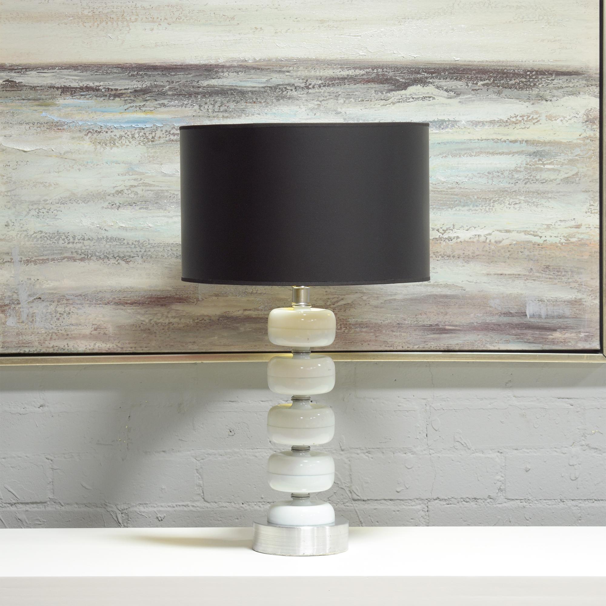 Dive into the exquisite world of mid-century design with our pair of mid-century modern table lamps, a remarkable representation of the period's artistic flair and innovation. Hand-crafted with precision, these lamps merge the delicate transparency
