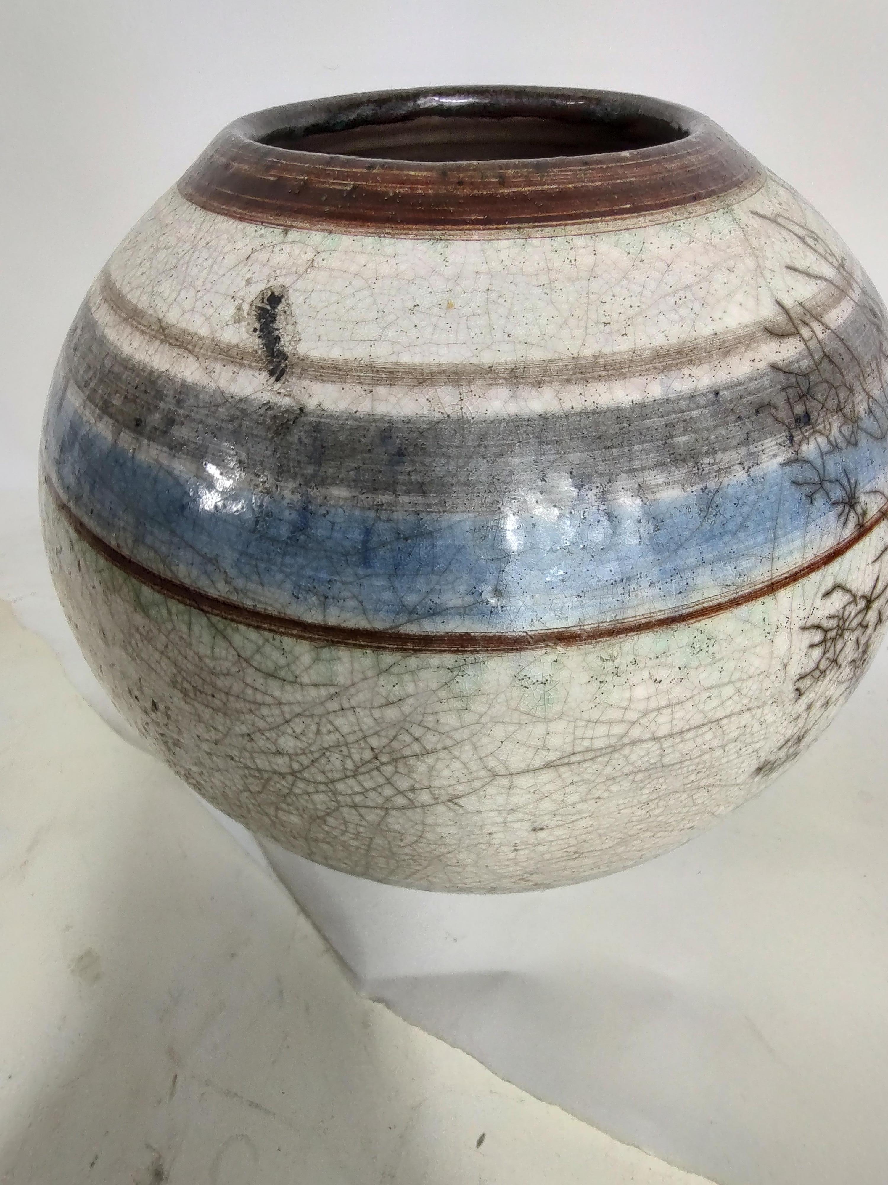 Fabulous hand thrown vase in the Mid-Century Modern arts & crafts style with crazed glaze. Intentionally glazed to look like fissures this vase is a true work of art. In excellent vintage condition with minimal wear.