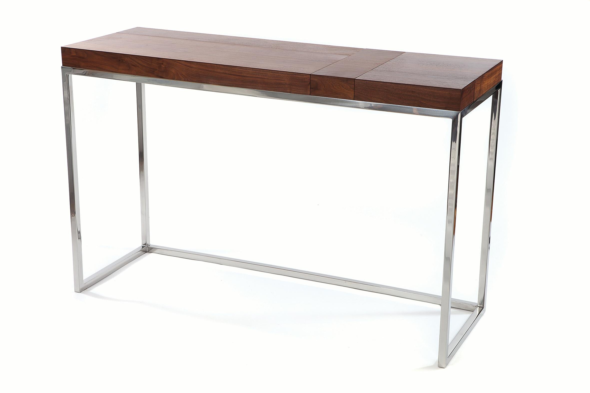 The Greta console consists of five trays; beautifully crafted from American walnut and set within a polished stainless-steel frame. Its 2” deep trays are ideal for the storage and display of personal belongings and accessories, such as jewelry, a