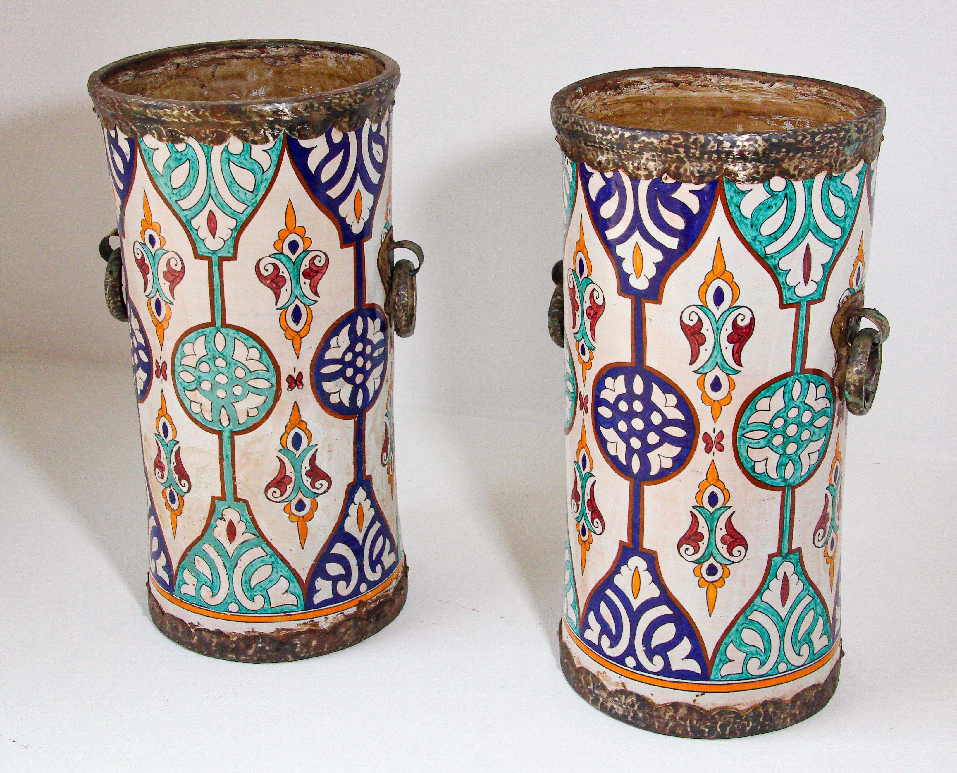 Pair of very decorative large handcrafted Moorish, Spanish style ceramic urns from Fez, 
Metal handles, bottom and top adorned with embossed metal.
Great decorative large ceramic vessels to use as planters, umbrella or can stand.
Will make a