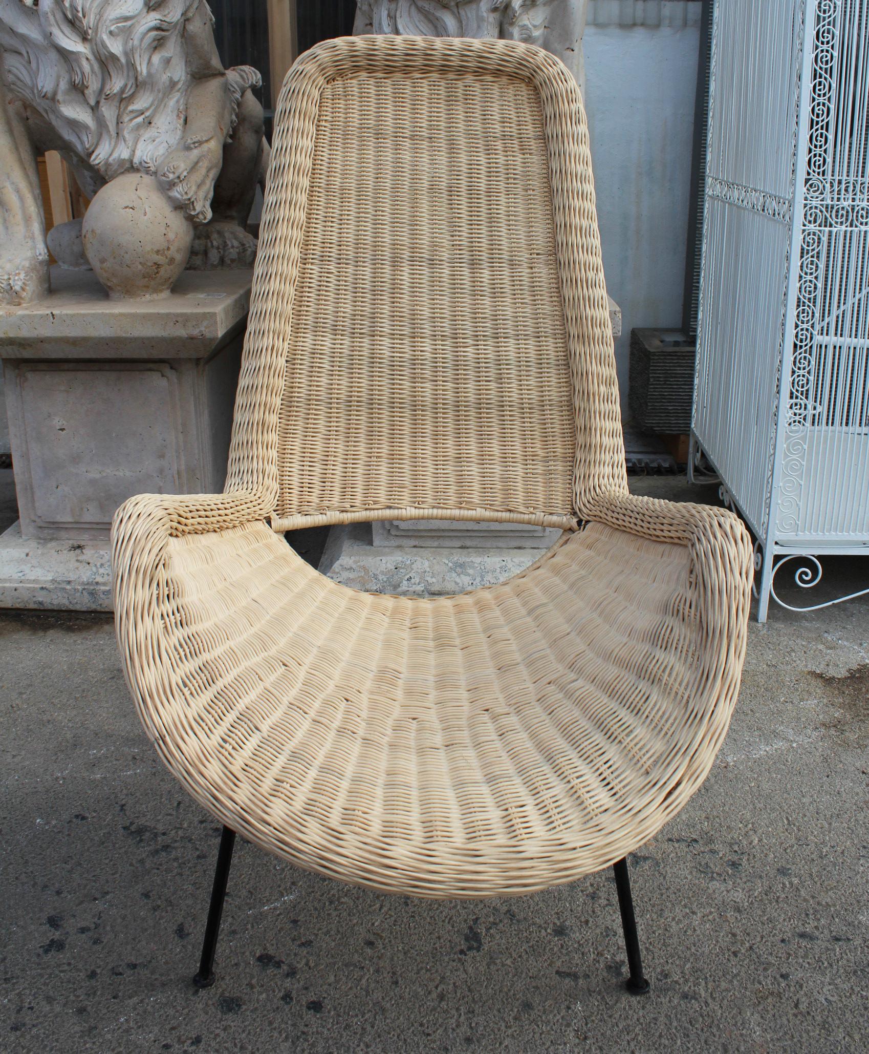 Hand crafted natural rattan chair with iron feet and back.