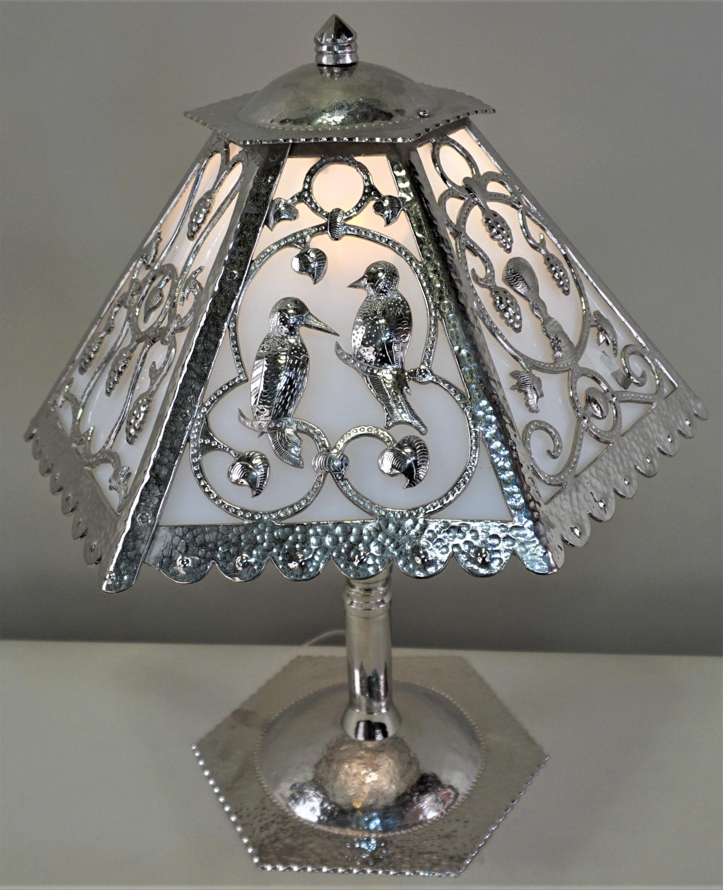 Handcrafted metal work, a rare and one of a kind French Art Deco table lamp. A metal smith masterfully created a six-panel shade, each with a different design, from three sections of heavy gauge bronze using a chisel and hammer. Base was created