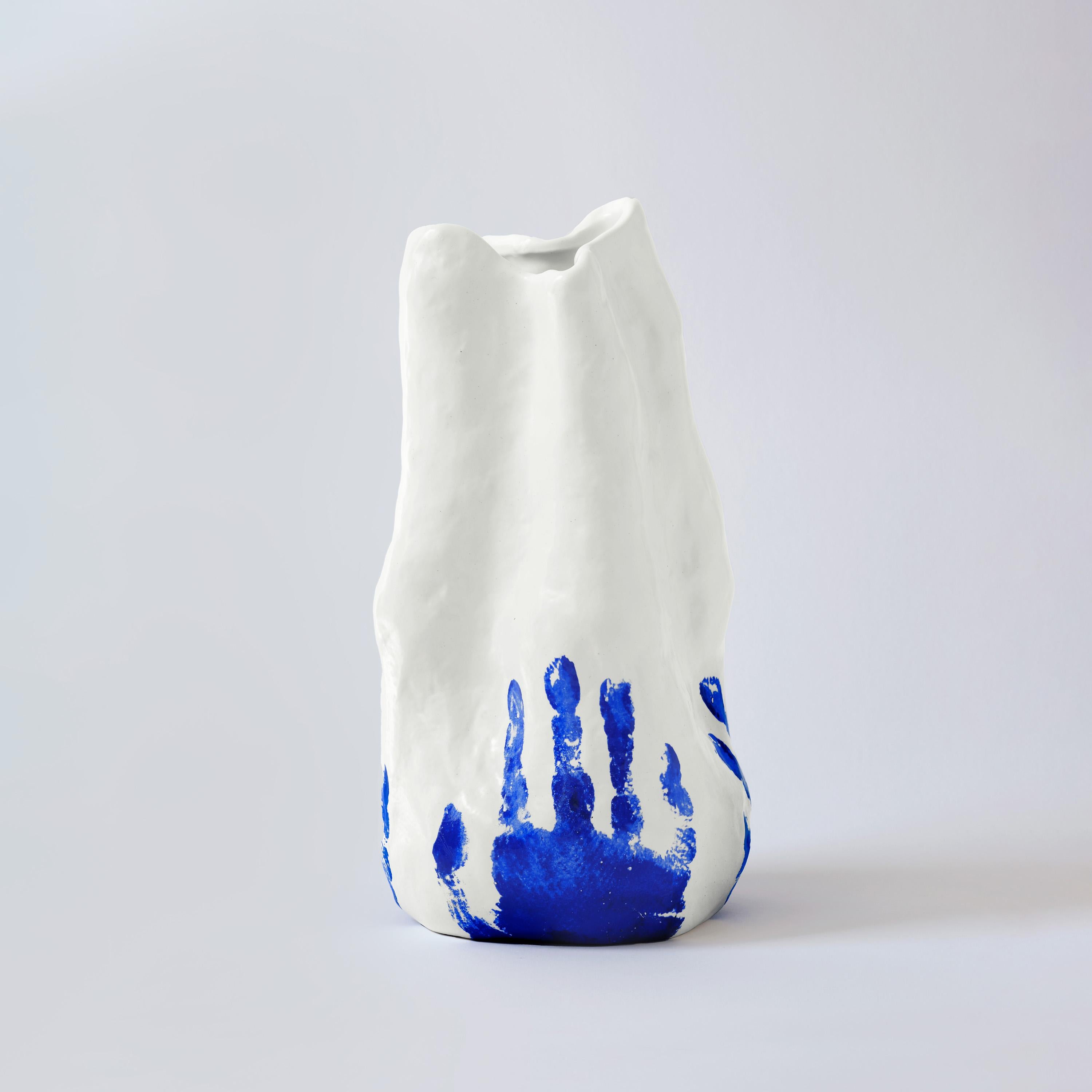 The Georgia vase, with its vibrant handprint color and unique shape, is inspired by the fearless creativity of Yves Klein's artistic vision. Crafted from China porcelain in Chaozhou, the renowned 'capital of porcelain,' with blue handprints produced
