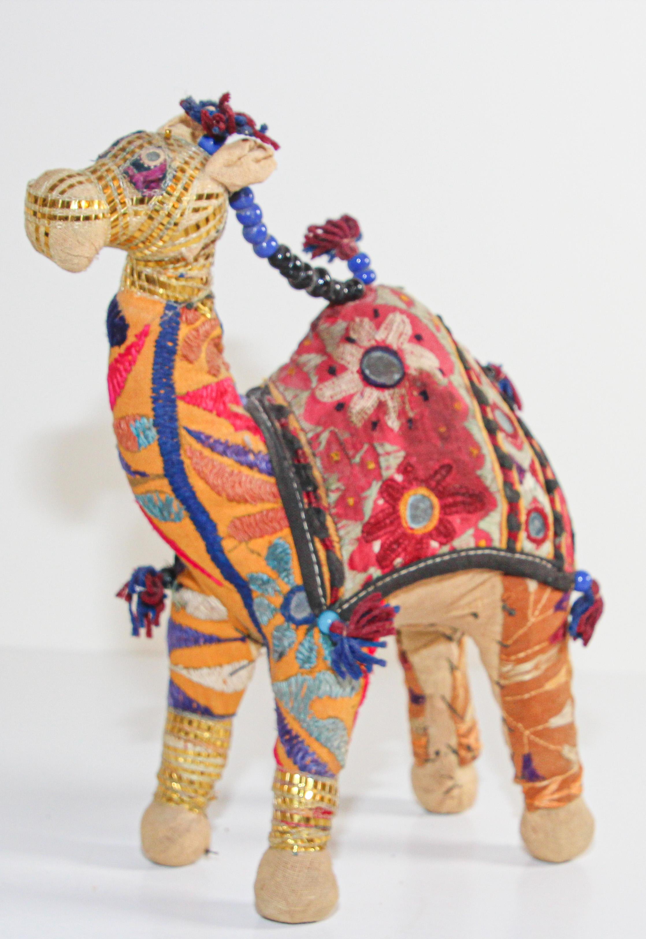 Handmade in Rajasthan, India, colorful fabric camel toy.
Vintage small camel stuffed cotton embroidered and decorated with small mirrors, great collector piece.
Anglo Raj, small stuffed camel wearing the ceremonial folk attire made from embroidered