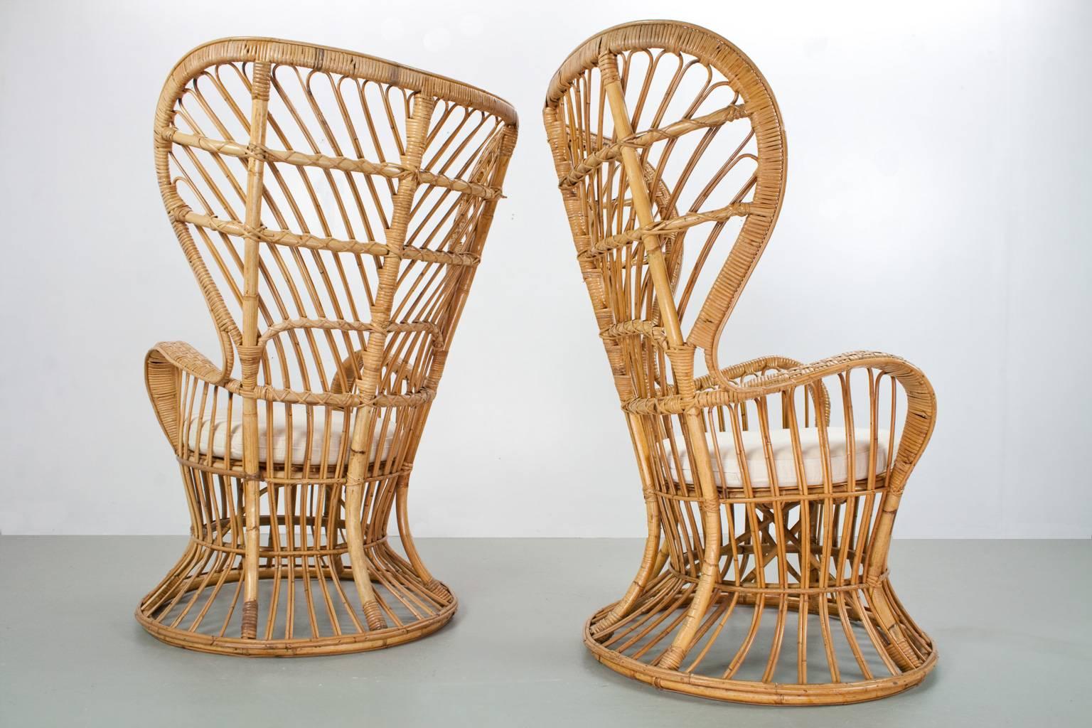 Italian elegant and hand crafted midcentury rattan high back armchairs designed by Lio Carminati in the 1950s and manufactured by Pierantonio Bonacina (Italy). The items were specifically designed for the prestigious cruise ship 'Conte Biancamano.'