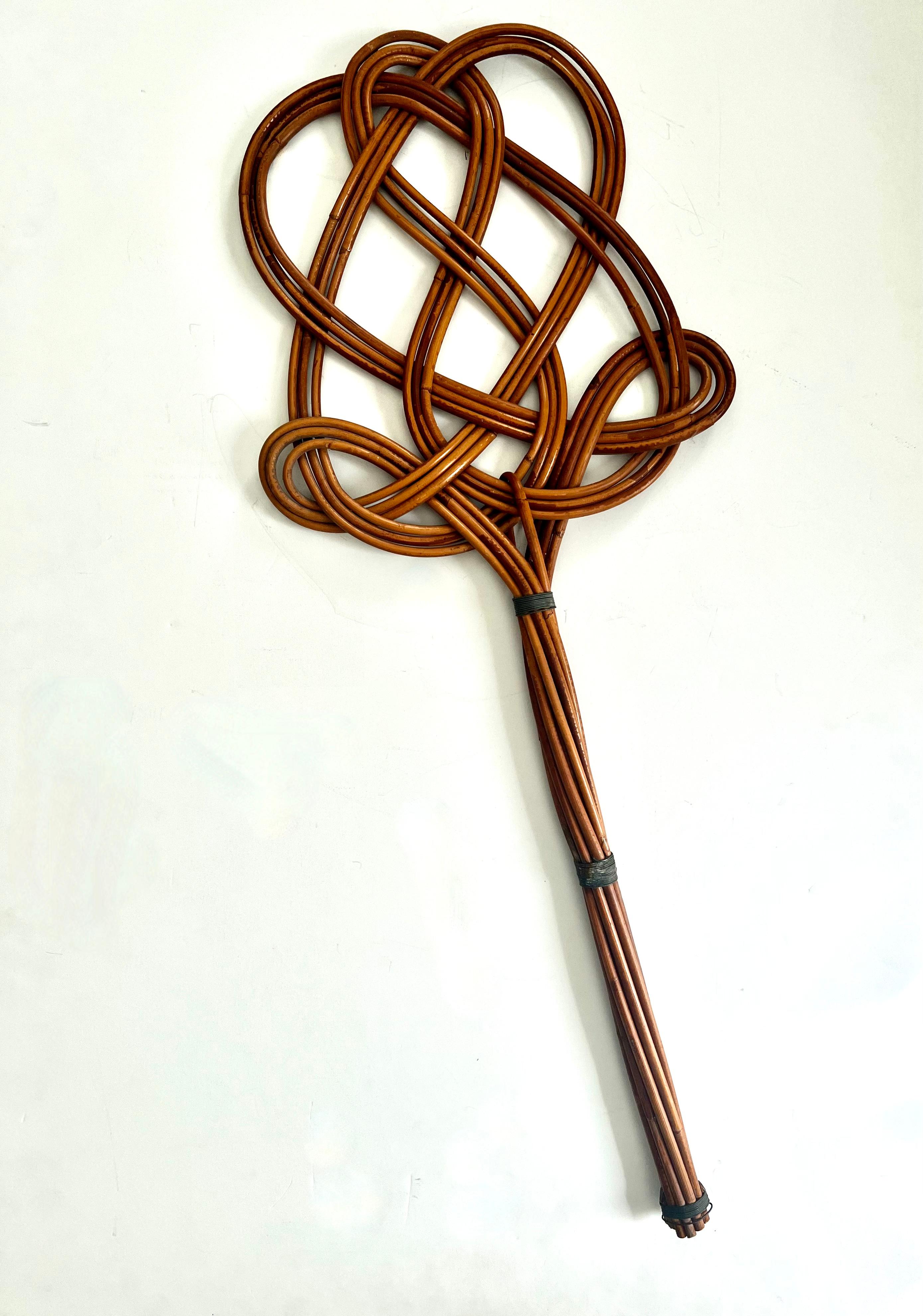 A hand made, hand woven Rattan Rug Beater... While fully functional and stable, this piece is also very decorative.

Could be used as placement on a wall with a story, on a console or simply leaning on the wall.
