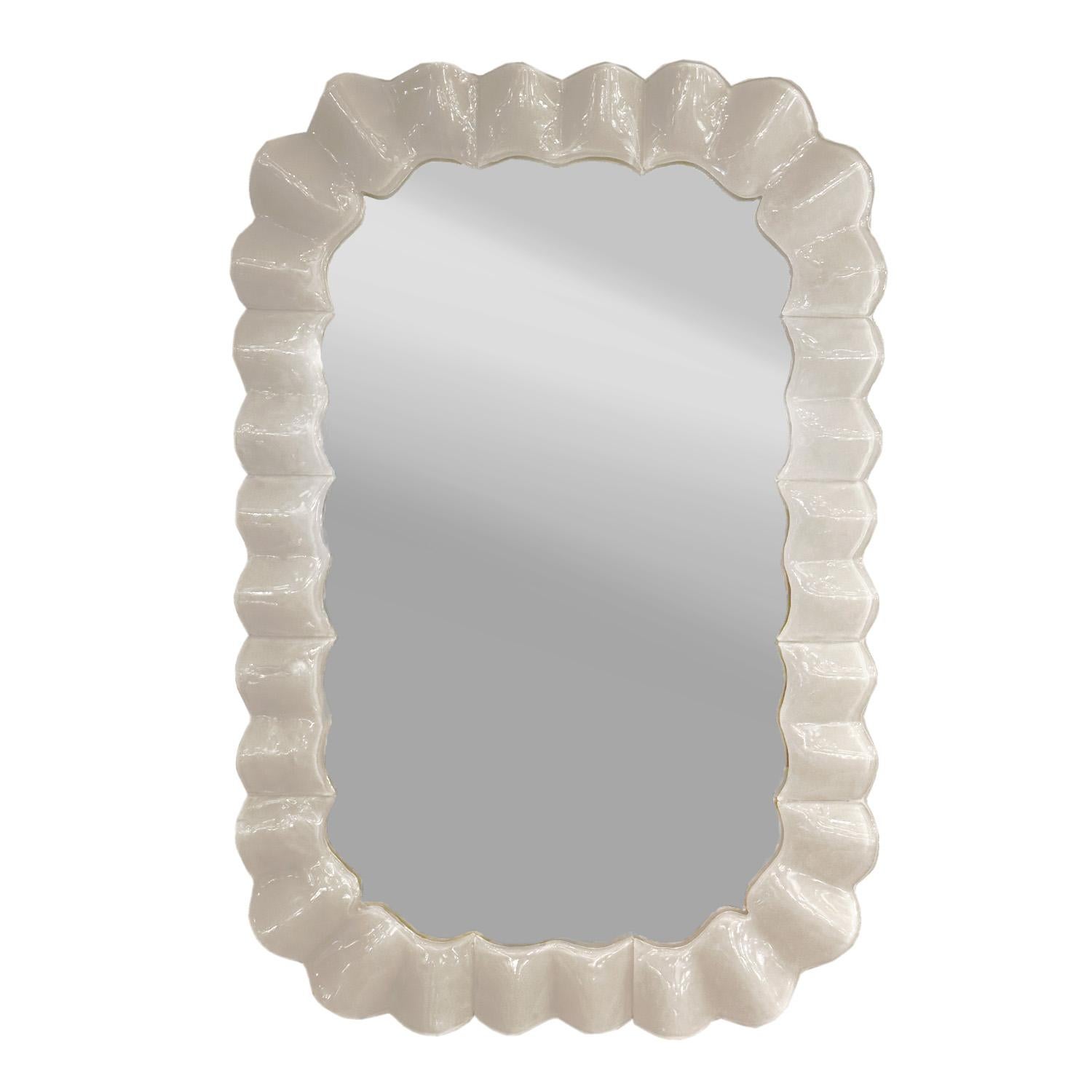 This handmade piece showcases the skill and artistry of Murano's glass makers, featuring a milk-white colored Murano lattimo glass frame with distinctive ruffled edges and radial corners. A narrow band of brass set back behind the milk glass frame