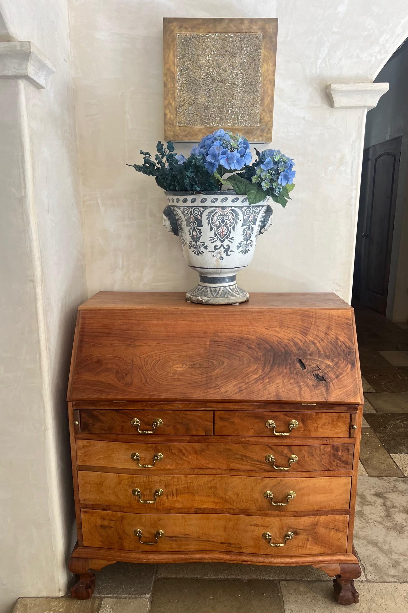 Classic secretary, hand made with ball and claw feet.  The secretary has five drawers with brass pulls on the bottom, with a slant front on top. The slanted top has a knotty feature of the wood. Once open it creates a writing space and includes five