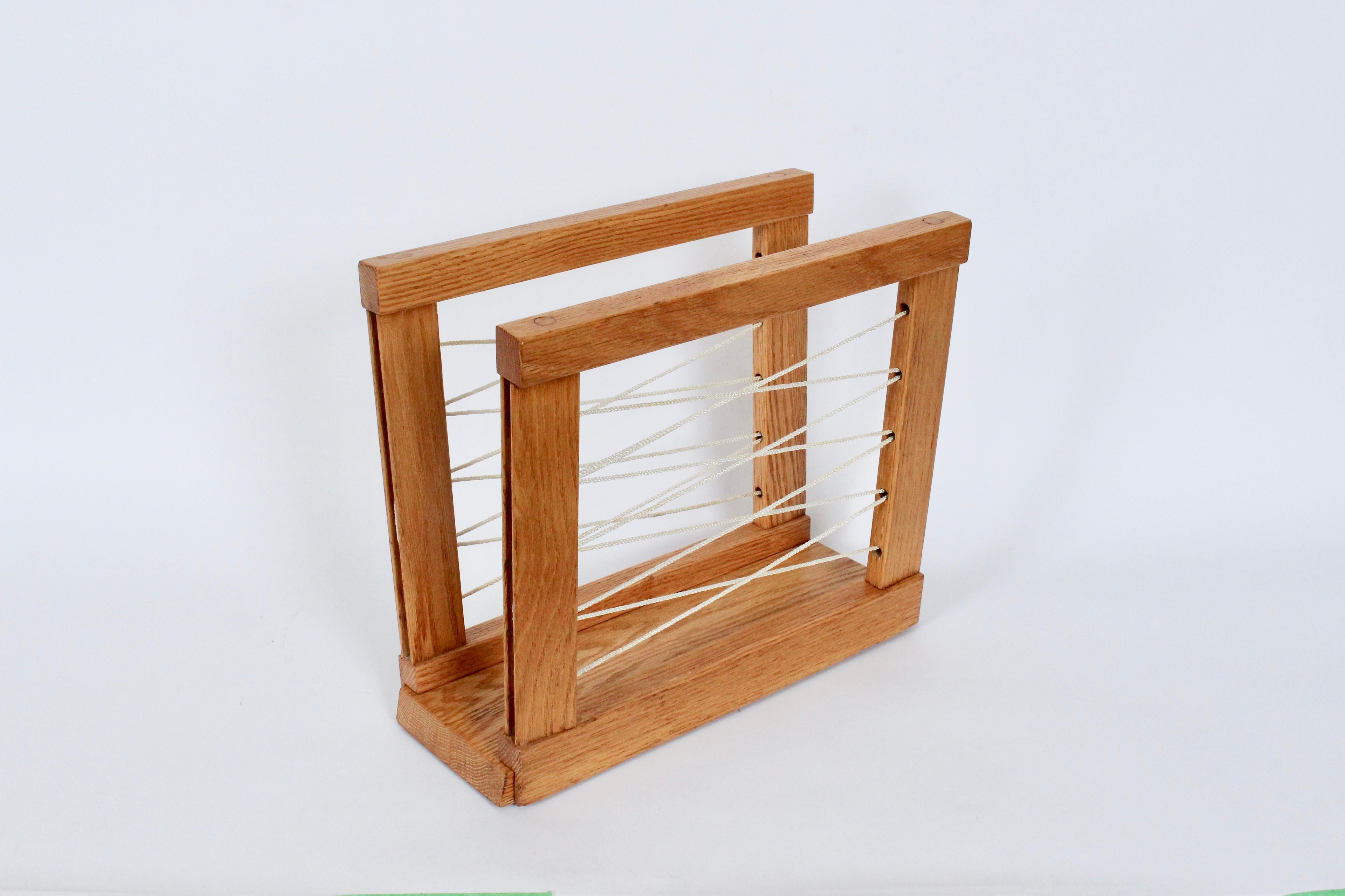 American Modern finely constructed Solid Oak and White Cord Magazine Stand, 1940's. Featuring a narrow and sturdy, handmade rectangular solid Oak framework with taut White Criss Cross Cord supports. Quality manufacturing. Versatile. File Folder.