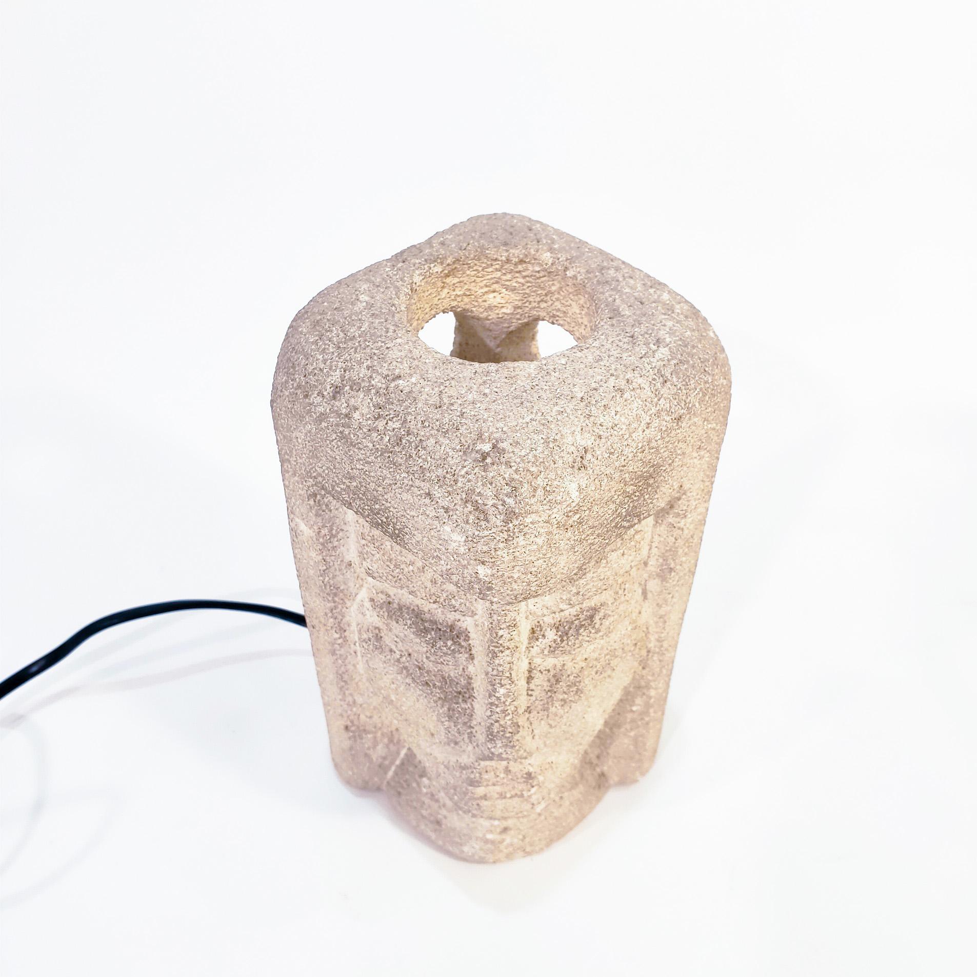 Stunning French table lamp from the 70s, designed and produced by the artist and sculptor Albert Tormos. This piece is made of natural stone worked and carved as a figurative female face, with holes on the sides through which light flows from