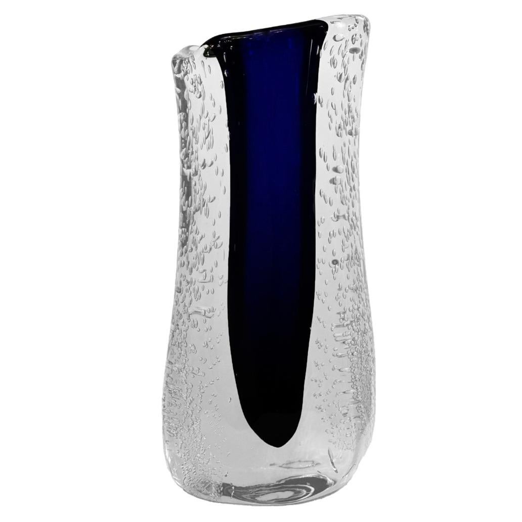 Elevate your space with this exquisite hand-crafted cobalt blue Murano sommerso glass vase with pullegoso, a testament to the unparalleled craftsmanship of Murano's glass masters. The elegant silhouette and deep, rich tone make it a standout piece.