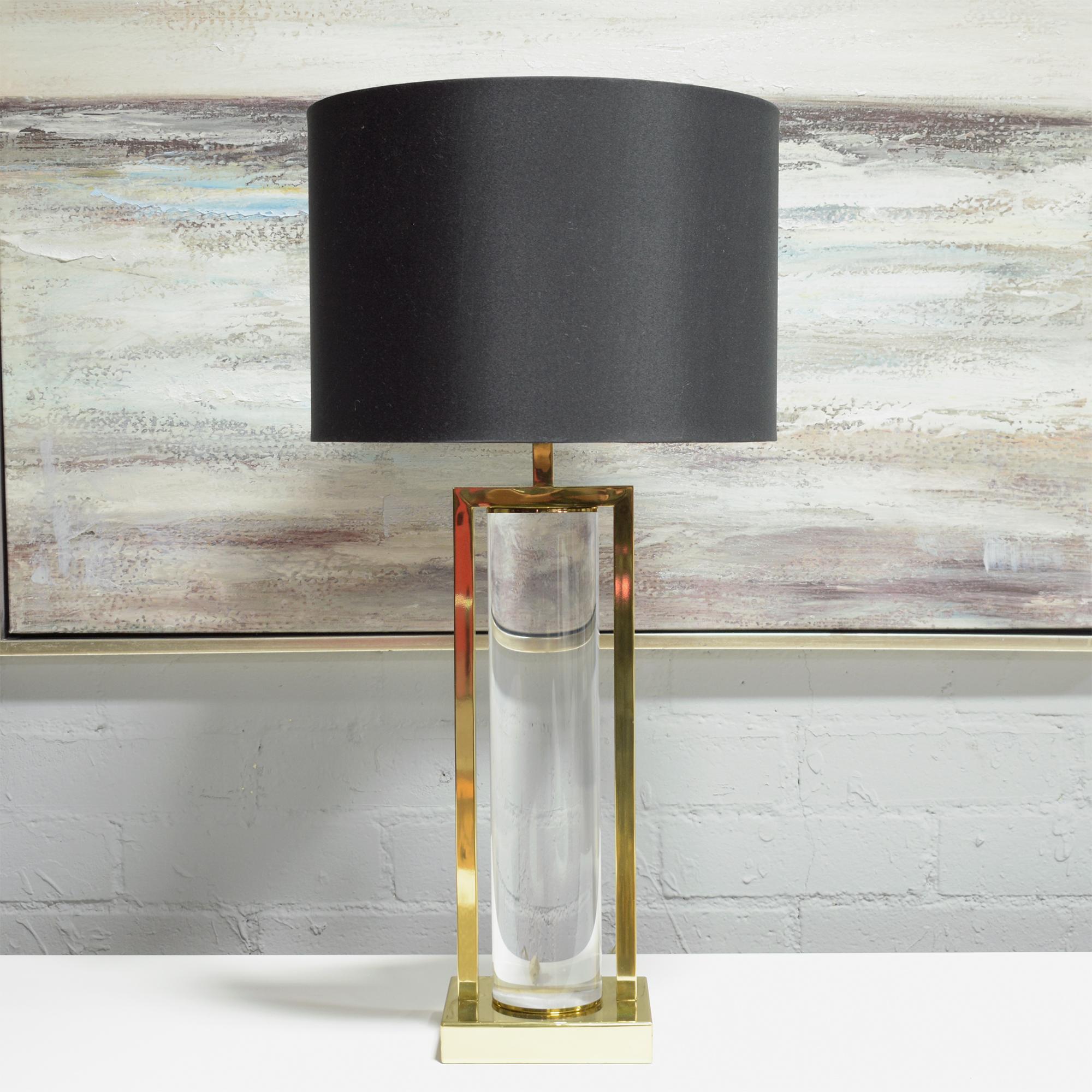 Discover the allure of vintage elegance with our meticulously hand-crafted mid-century modern table lamp. This stunning piece, standing testament to the iconic design era, combines the timeless beauty of brass with the modern appeal of transparent