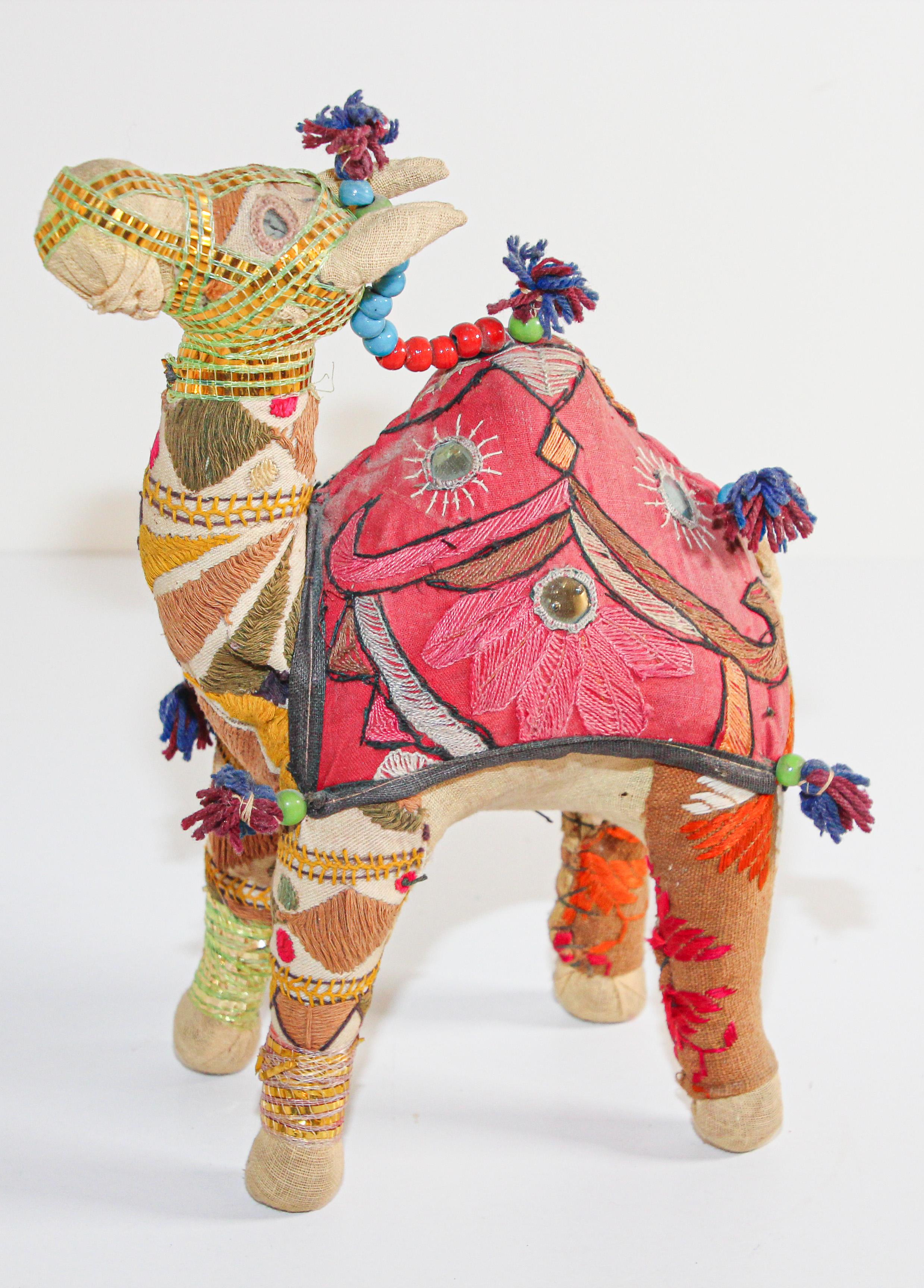 Handmade in Rajasthan, India, colorful fabric camel toy.
Vintage small camel stuffed cotton embroidered and decorated with small mirrors, great collector piece.
Anglo Raj, small stuffed camel wearing the ceremonial folk attire made from