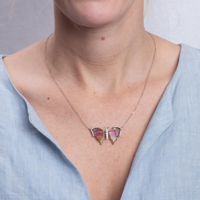 This beautiful and one of a kind necklace was created in house by our master jewelers. It features a hand crafted watermelon tourmaline in the shape of a butterfly accented by 0.20 carat total weight in round diamonds set in 14 karat white gold. It