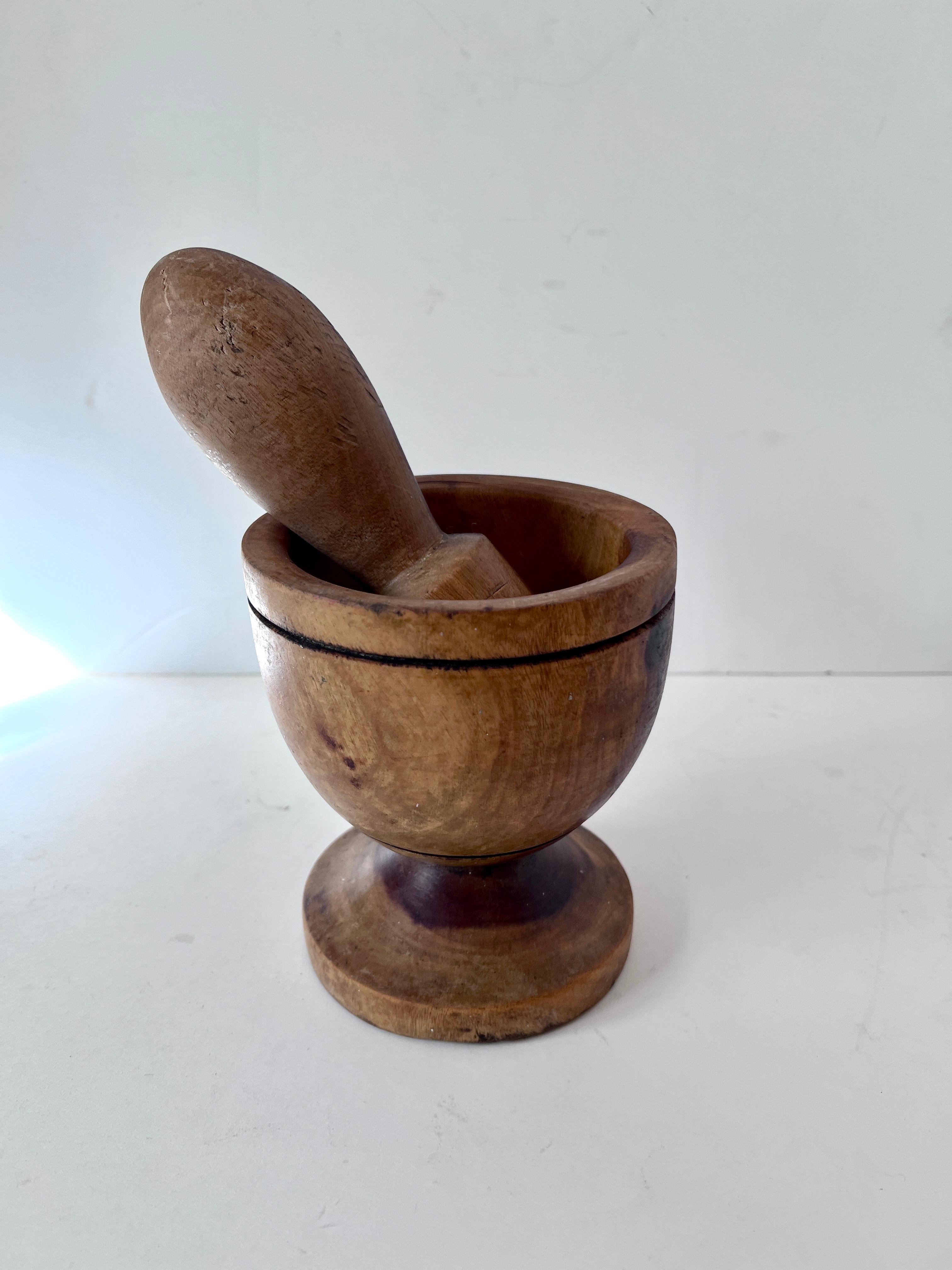 A well crafted wooden Folk Art Mortar and Pestle.  The piece is used for crushing everything from herbs and spices, to medicines.  While the piece is practical, the wooden craftsmanship makes it an equally Wonderful decorative piece.

when polished,