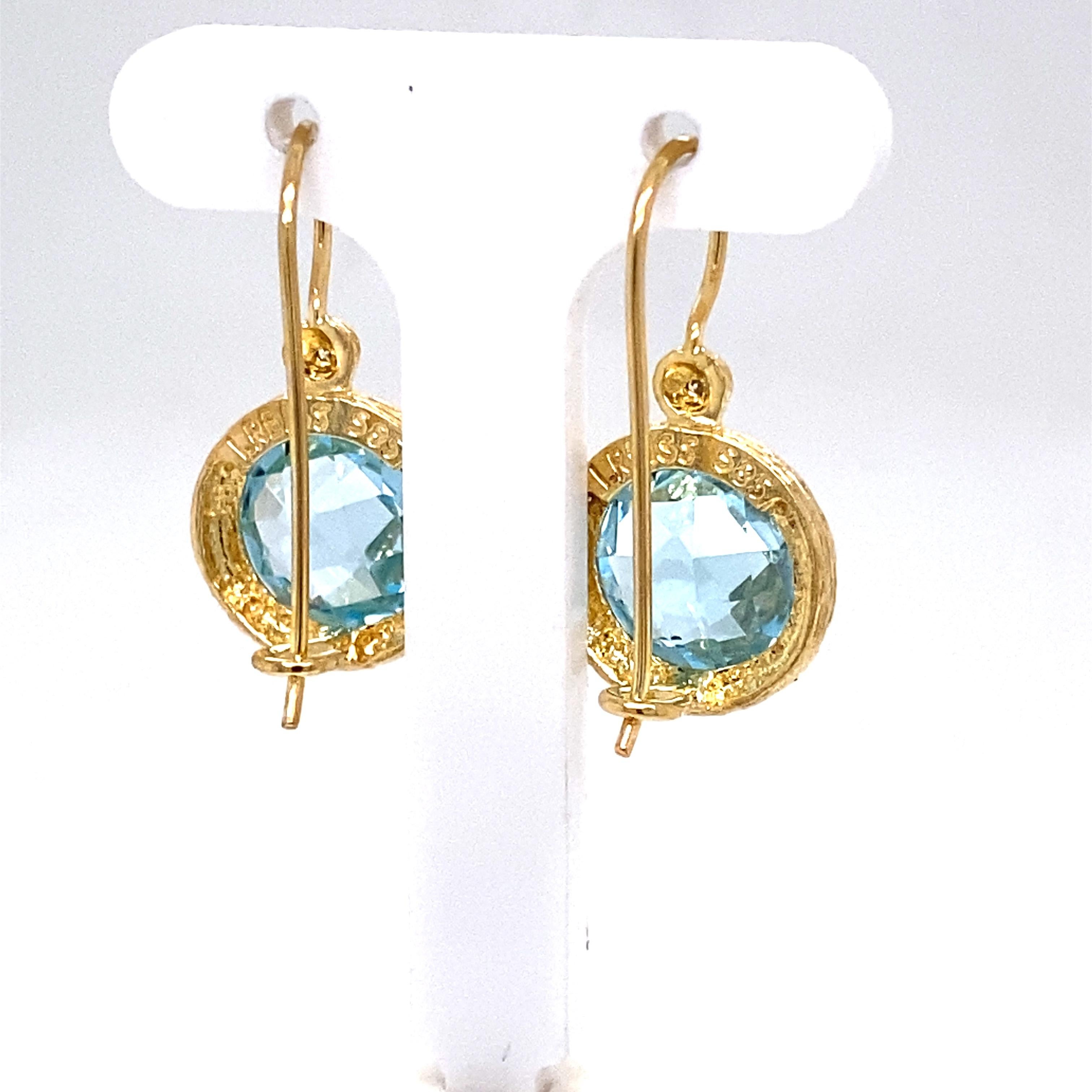 14 Karat Yellow Gold Hand-Crafted Polish-Finished and Textured Drop Earrings, Centered with a 10mm Semi-Precious Round Checkerboard Blue Topaz Color Stone Accented with 0.03 Carats of Bezel Set Diamonds.
