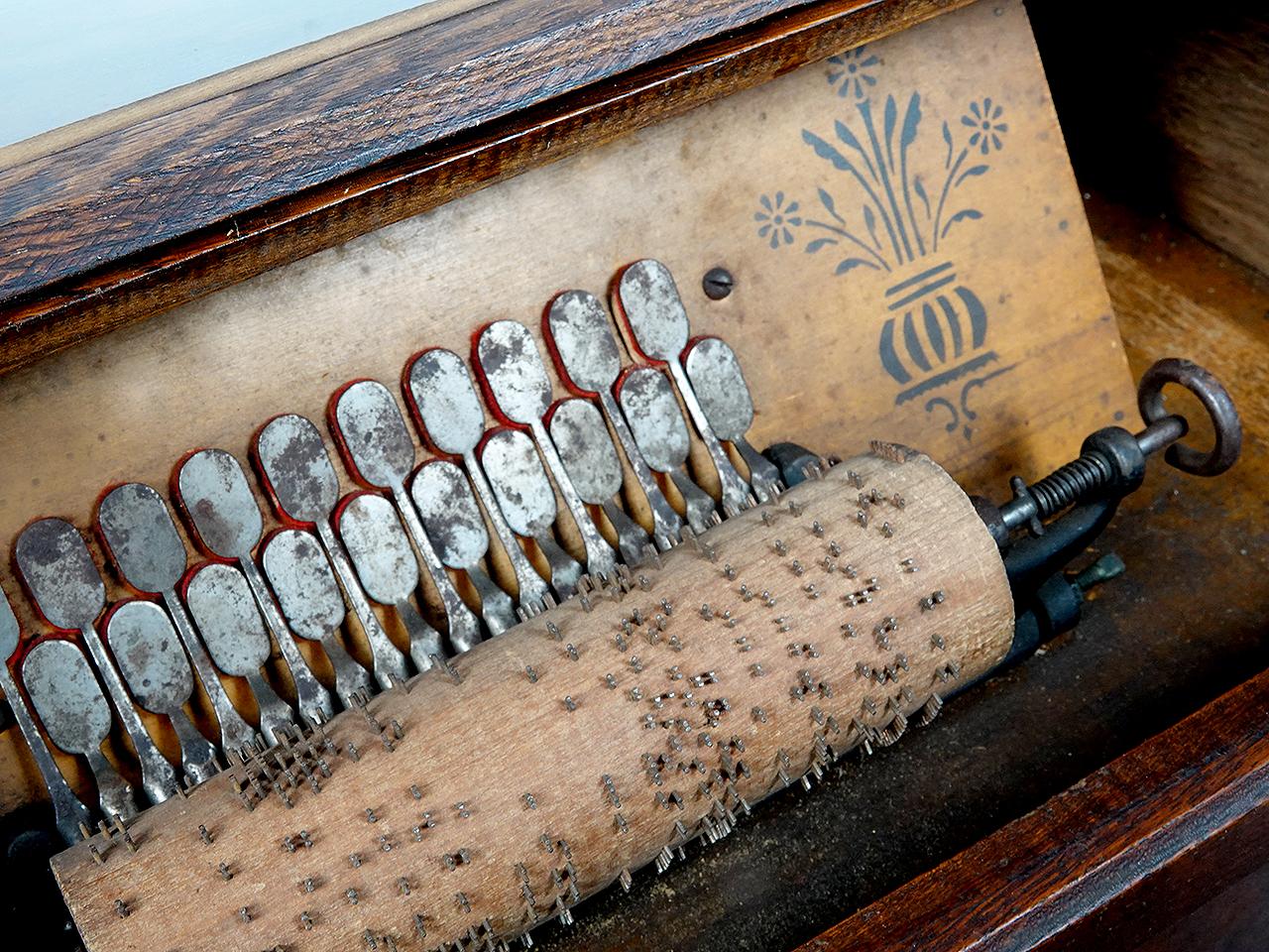 This roller organ was most likely made by the Autophone Company in Ithaca, New York, around 1885-1899. It is a Concert 20-note model, with 20 reeds and a hinged glass front cover. This roller organ plays a metal-pin-studded wooden cylinder also