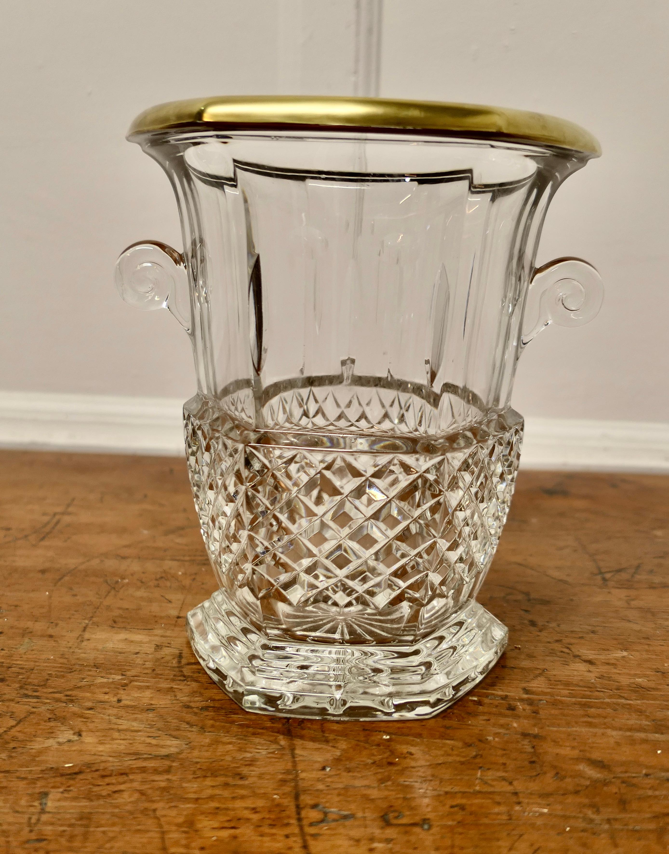 Hand Cut French Art Deco Crystal Wine Cooler with Gilded Top Rim

An Attractive Art deco piece, in a 6 sided shape with a star-shaped base and diamond cut pattern set off with a Gilt Rim and escargot handles

The cooler or Ice bucket is very heavy,
