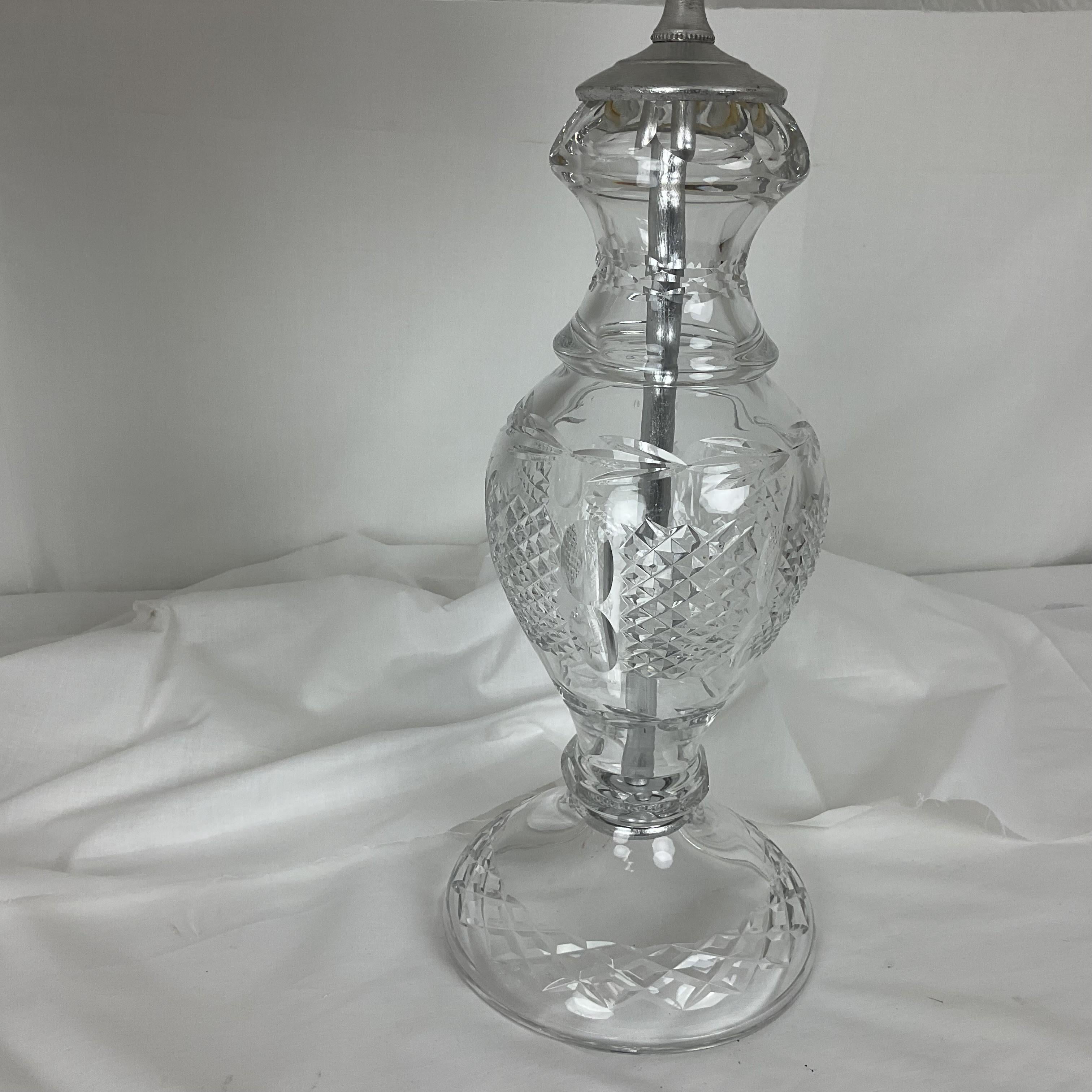 Brighten up your home with this stunning pair of Full Lead Crystal lamps. Featuring beautifully crafted crystal bases with intricate cut designs, these lamps add timeless elegance to any room. Each lamp comes with a classic white fabric shade that
