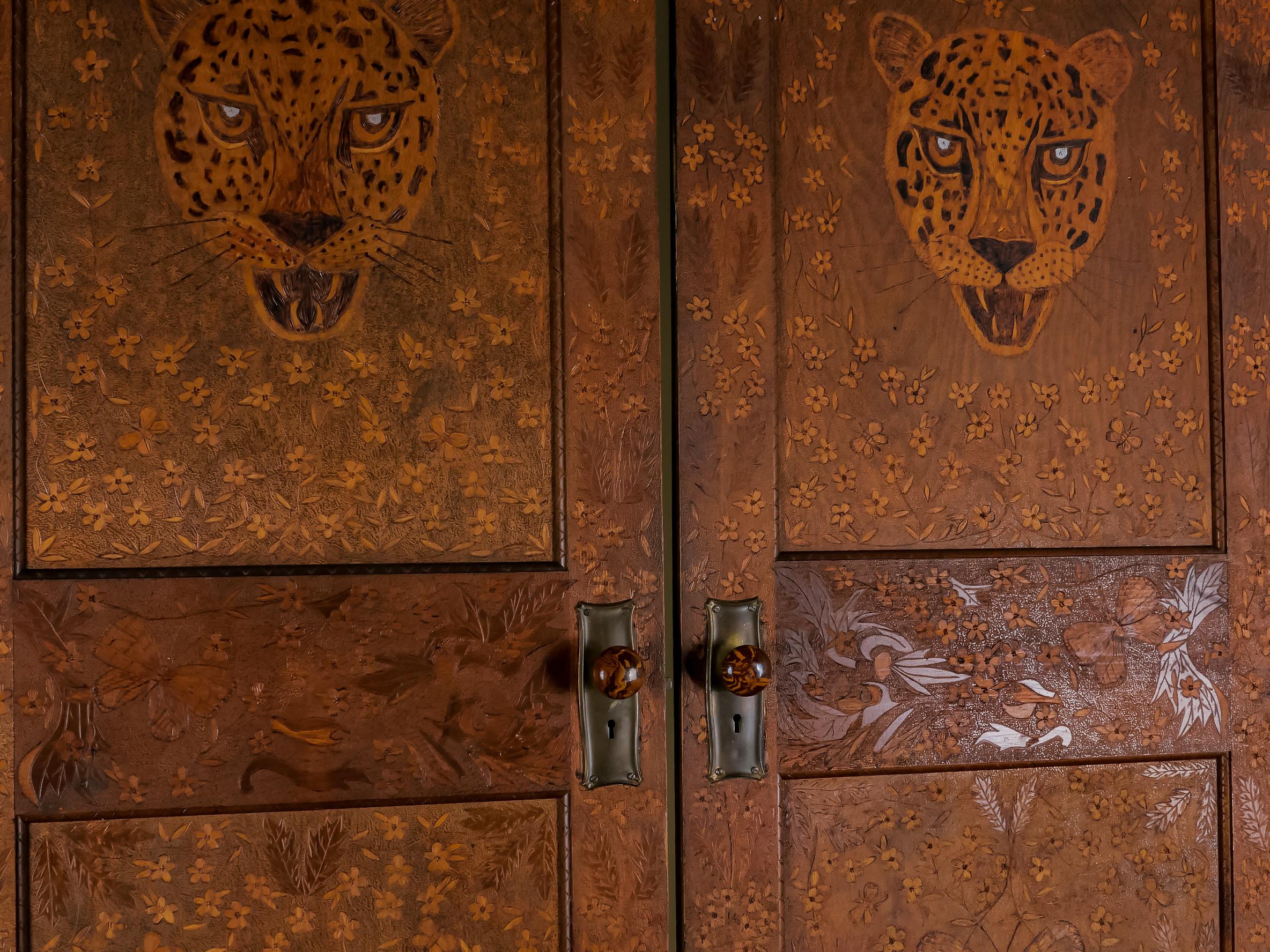 Ohio, circa 1910. Hand-carved and decorated. These magnificent folk art interior doors are single panel, solid core and painted white on the reverse sides. Hardware has been added; Bennington Potters ceramic knobs seemed fitting with the motifs. The