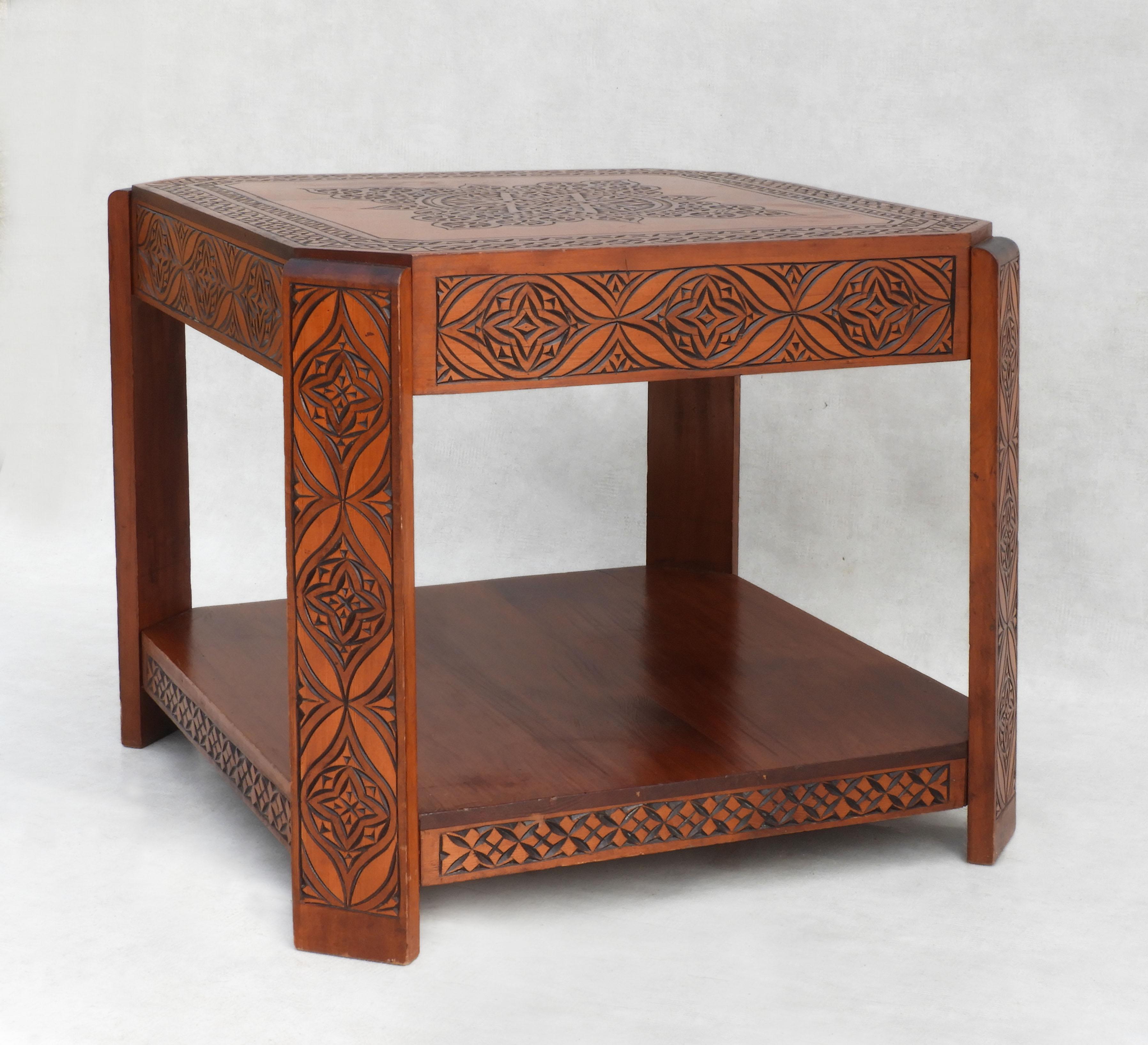Vintage Moroccan hand-decorated coffee table C1950
Attractive two-tier square format with late Art Deco style curved accents.
Hand-carved with Moorish floral and geometrical designs.
A nice Bohemian accent addition to any room.  In good vintage
