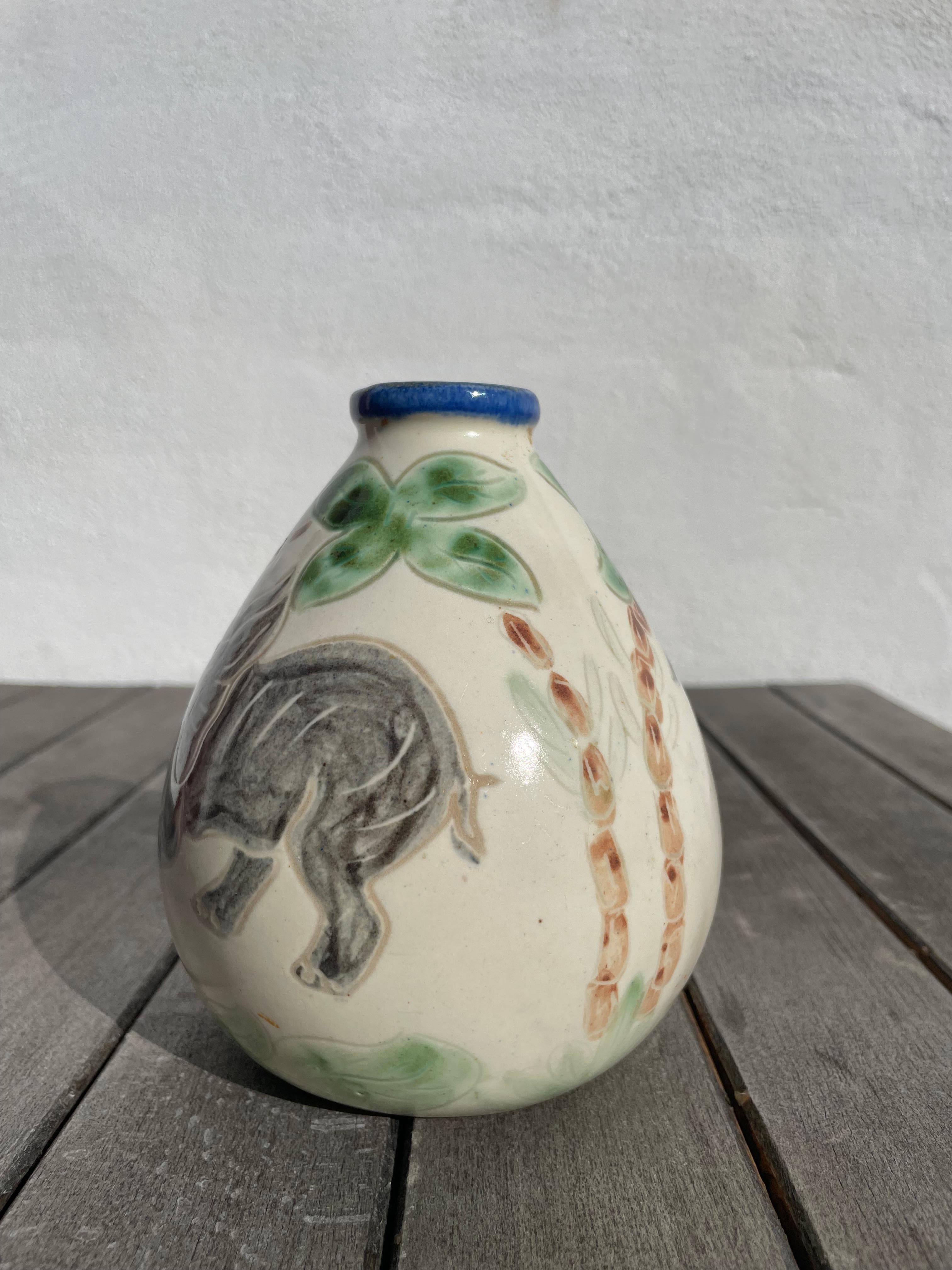 Danish soft shaped vase with hand-painted elephants and palmtrees. Light yellow glaze with blue top edge and green organic decor. Manufactured by Grimstrup Keramik. Signed and stamped under base. Beautiful vintage condition.
Denmark, 1950s.