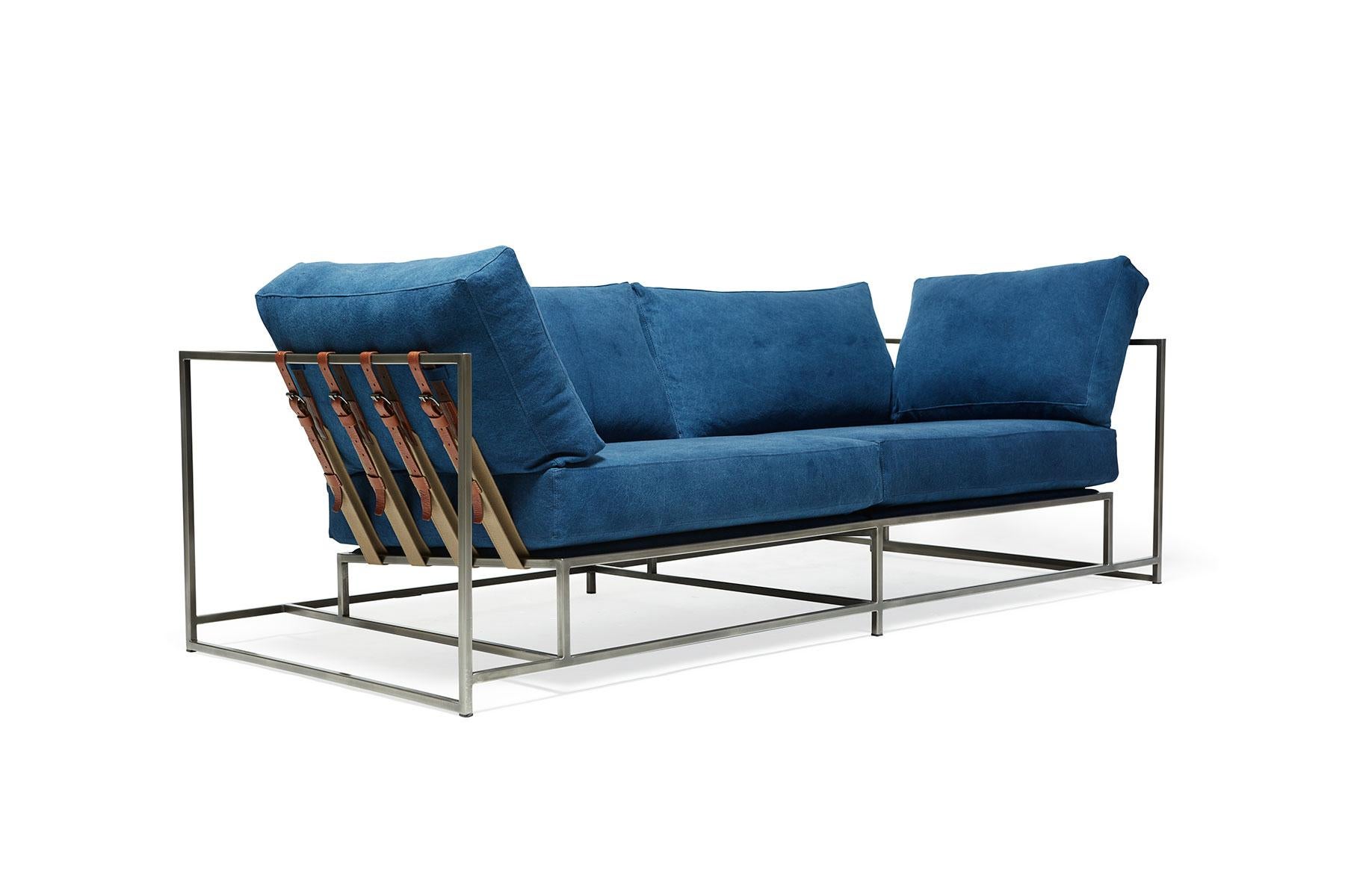 The Inheritance Two Seat Sofa by Stephen Kenn is as comfortable as it is unique. The design features an exposed construction composed of three elements - a steel frame, plush upholstery, and supportive belts. The deep seating area is perfect for a