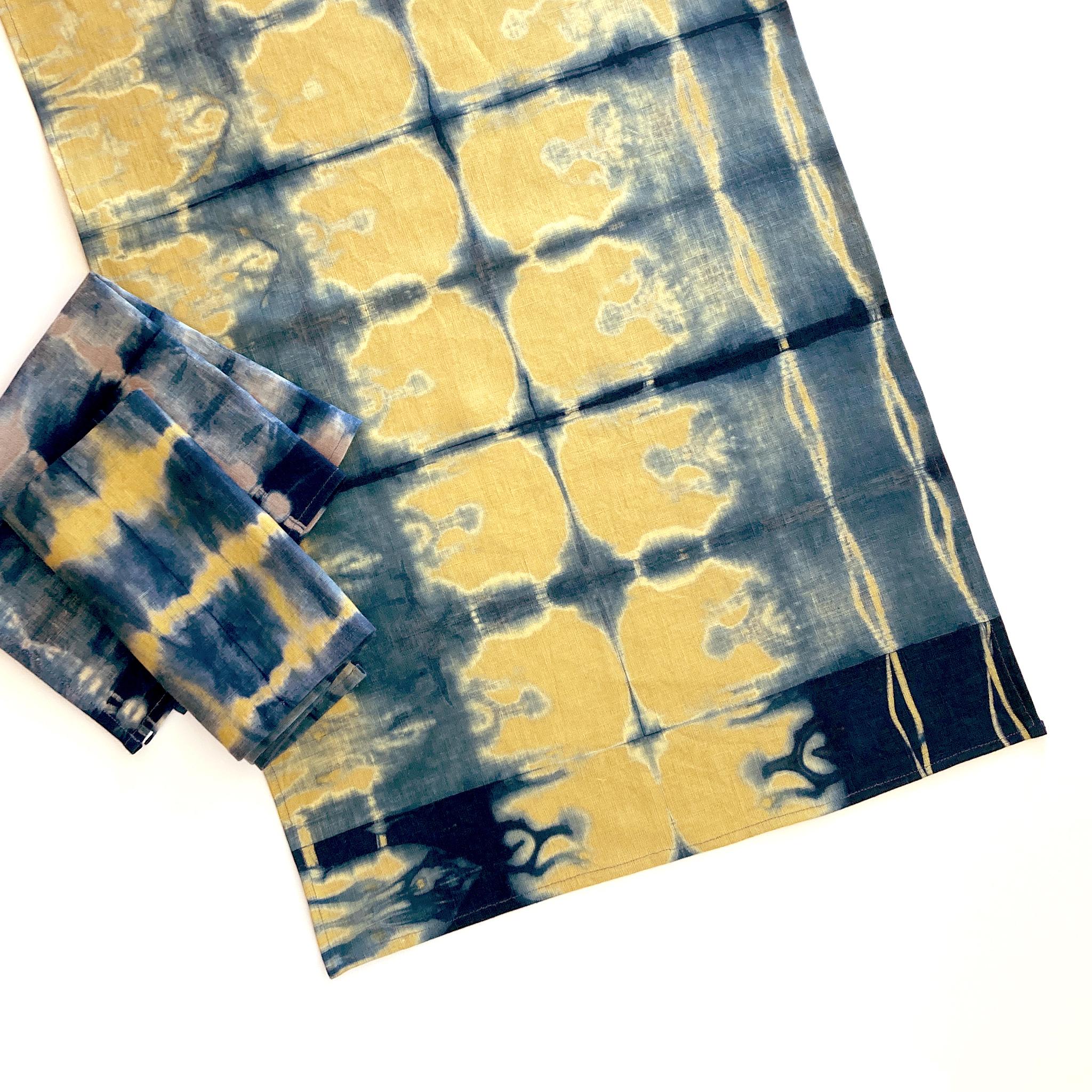 Mustard gold linen table runner dyed with indigo in Pleat pattern. Hand-dyed and sewn in New York City. Runner measures approximately 18 x 72 inches. Each linen runner is hand dyed and one of a kind. 

Each linen panel is cut and folded by hand, in