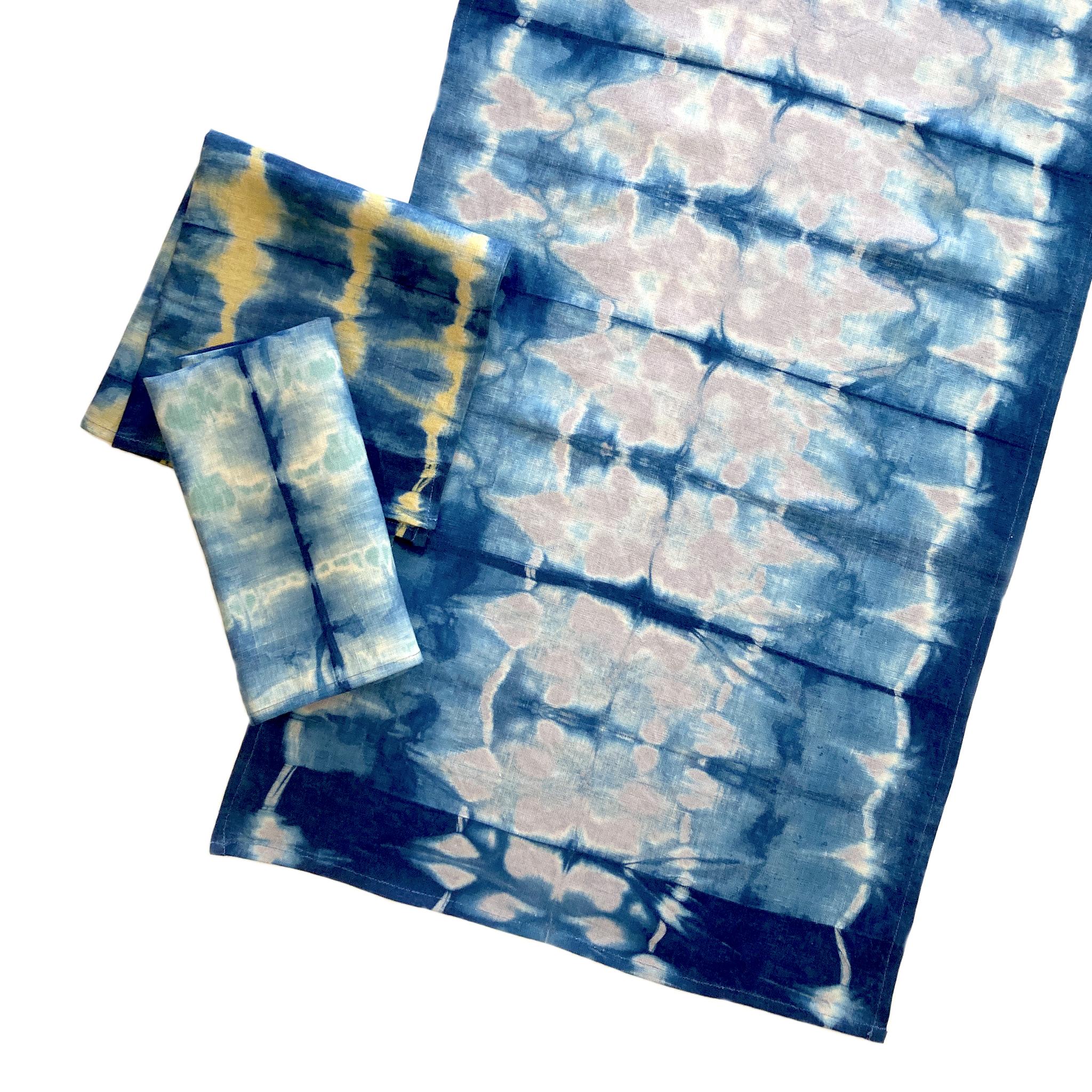 Silver gray linen table runner dyed with indigo in Pleat pattern. Hand-dyed and sewn in New York City. Runner measures approximately 18 x 72 inches. Each linen runner is hand dyed and one of a kind. 

Each linen panel is cut and folded by hand, in