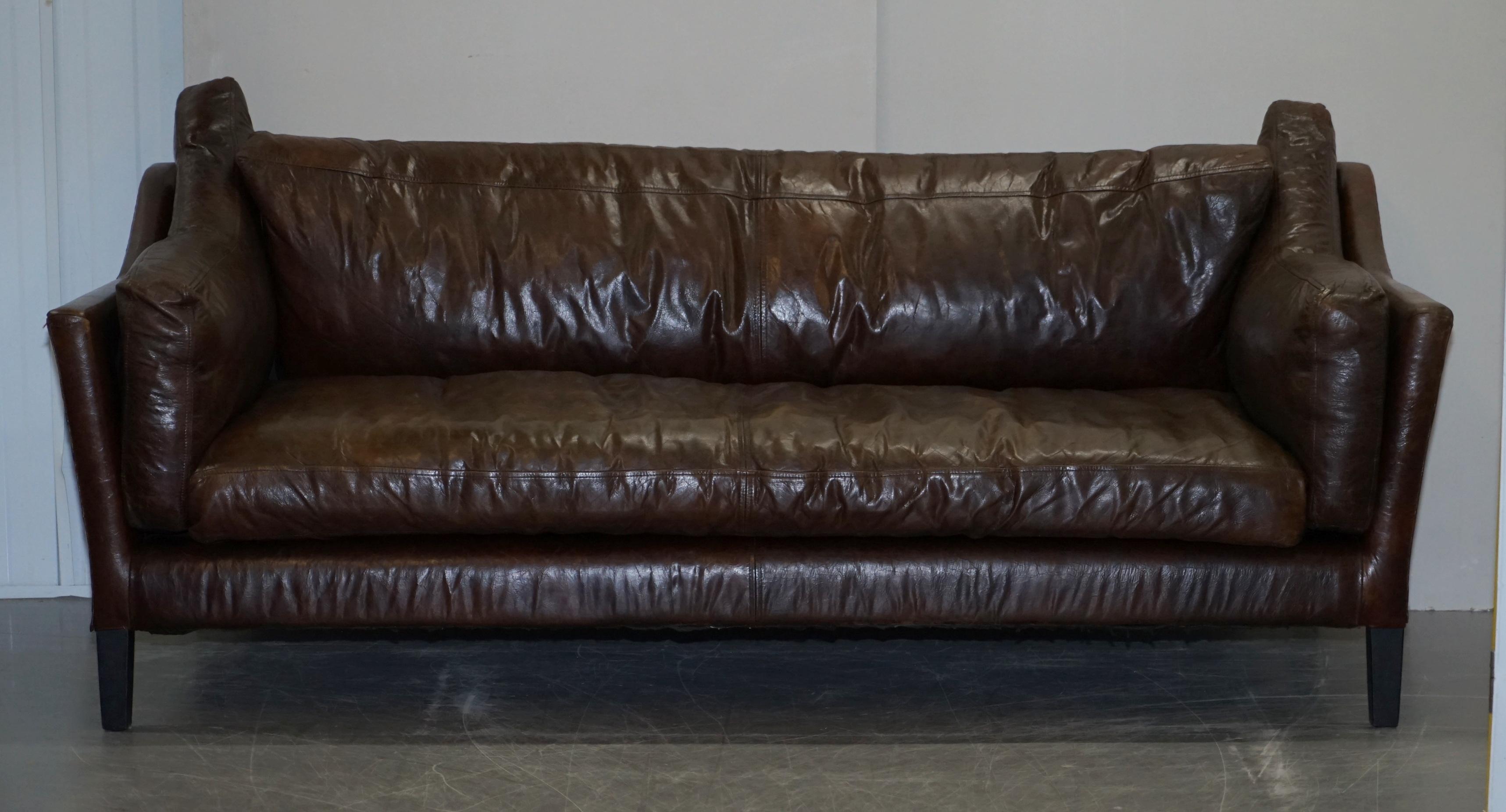 We are delighted to offer for sale this very comfortable had dyed brown leather designer styled three seat sofa

A very good looking decorative and comfortable sofa, this piece came from Dublin in Ireland, it has a very cool art modern look and