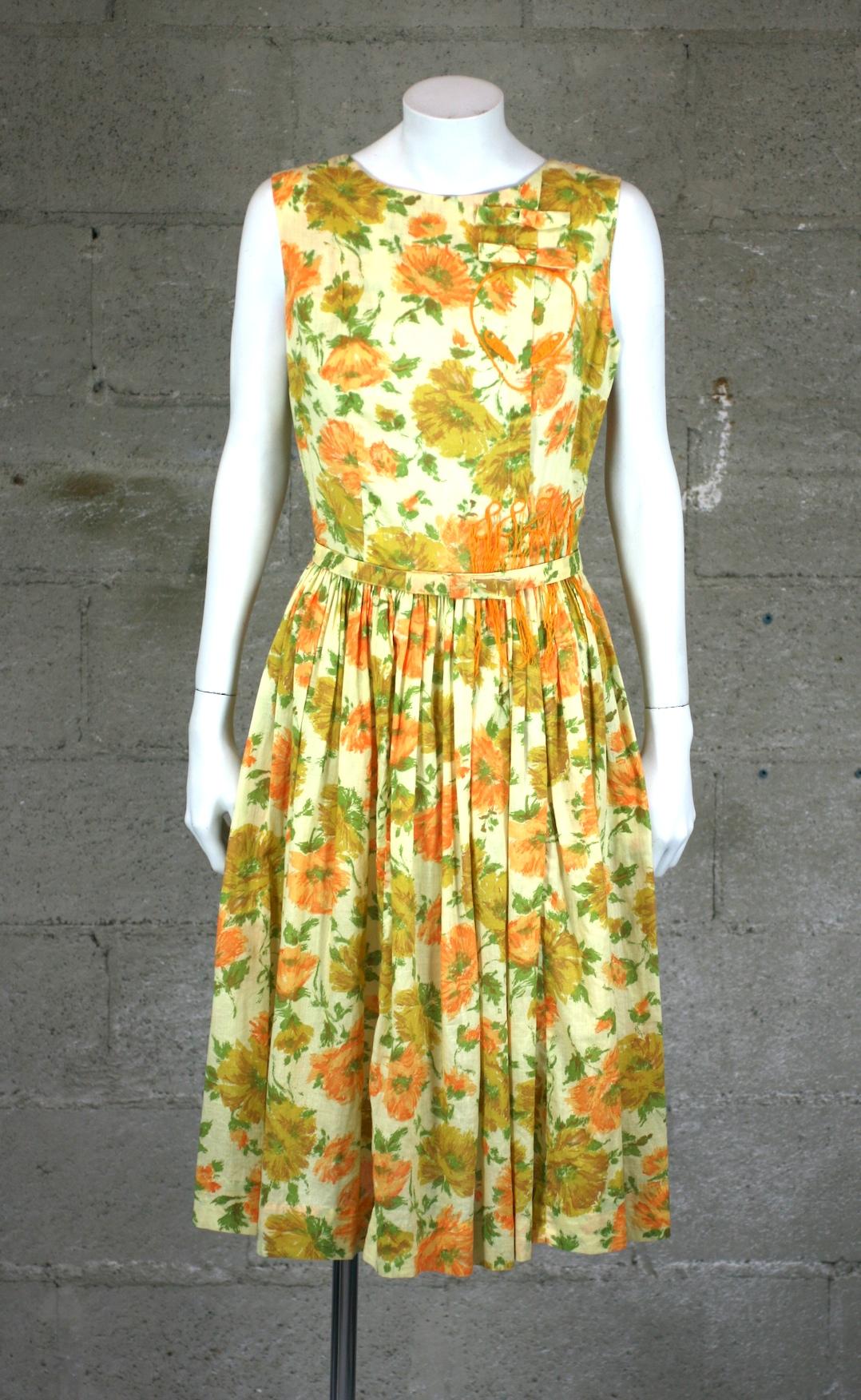 Upcycled 1950's Dress with a muted print of sunflowers on a soft cotton batiste by Studio VL. Typical wasp waist styling with self belt with bow motif. 
We have hand embroidered an subtle alien head motif (with a bow in her hair) as well as the zip