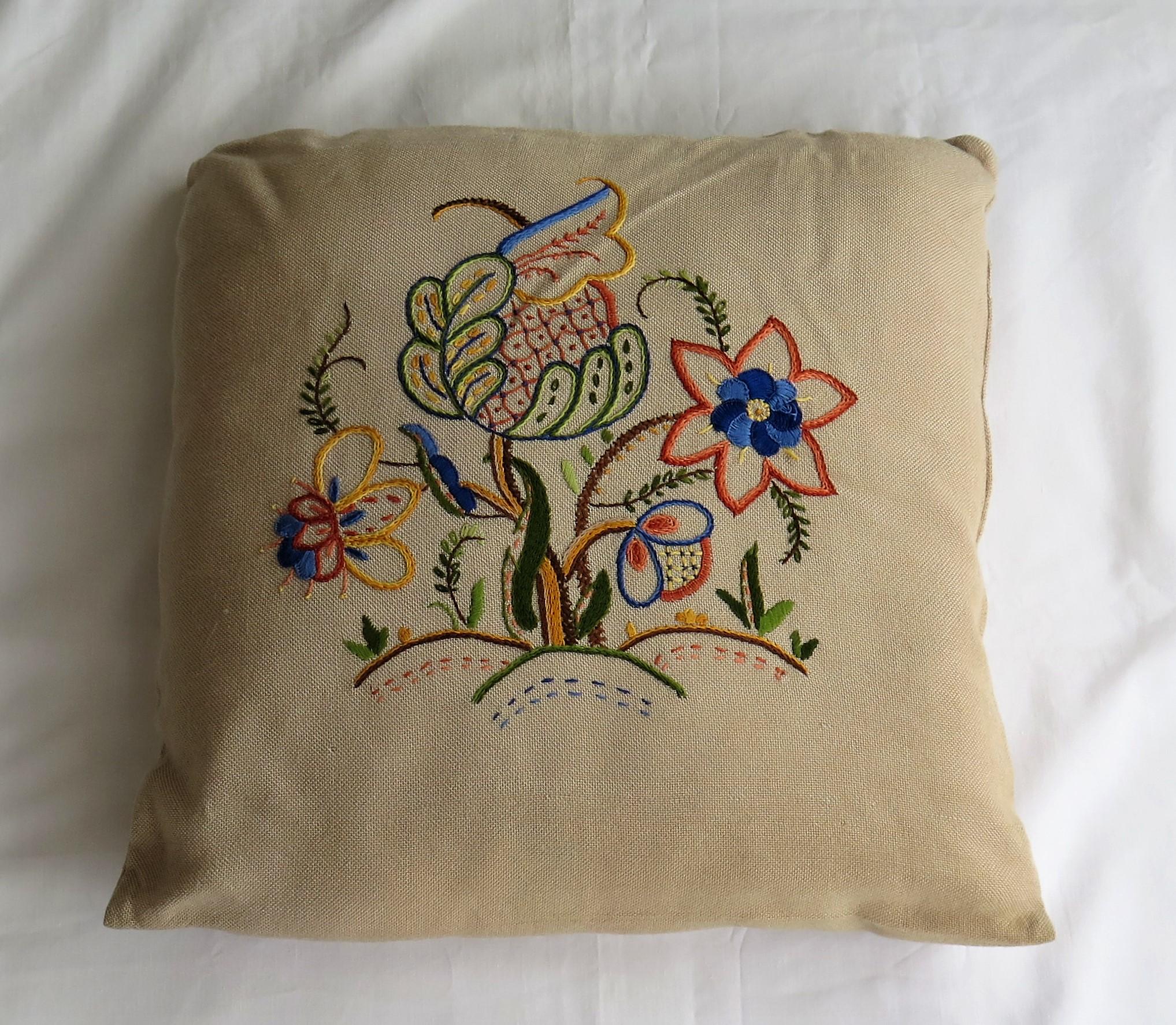This is a very decorative cushion or pillow with hand embroidered stylised flowers, which we date to the mid-20th century, circa 1940.

The pillow is about 15 inches square.

The decoration features beautifully hand embroidered stylised flowers