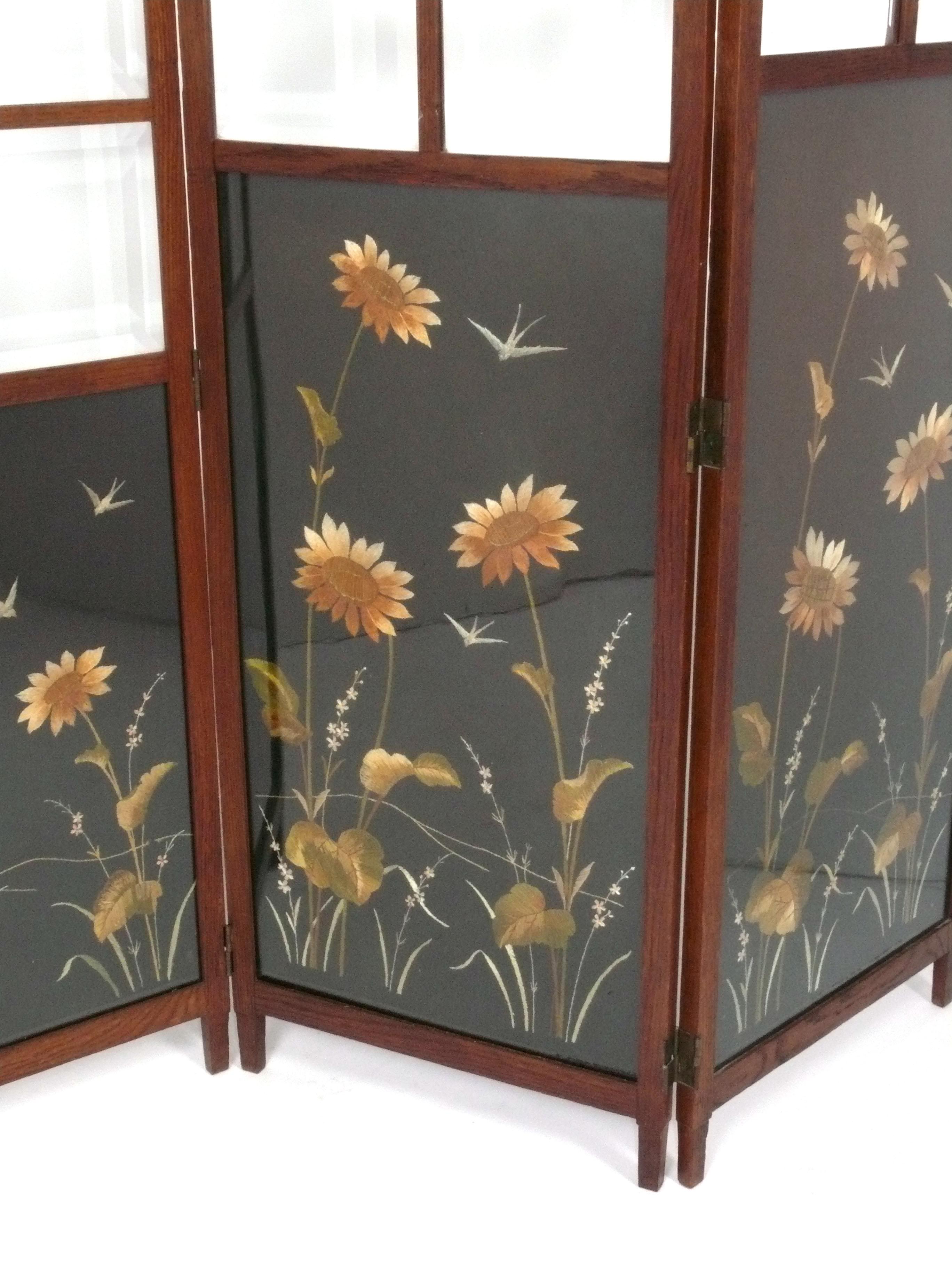 Beautiful Hand Embroidered Arts and Crafts Era Folding Screen, American, circa 1910s. The embroidered design depicts a flower filled meadow with swallows flying through the air. This design is attributed to Matthew Andrew Daly, who designed numerous