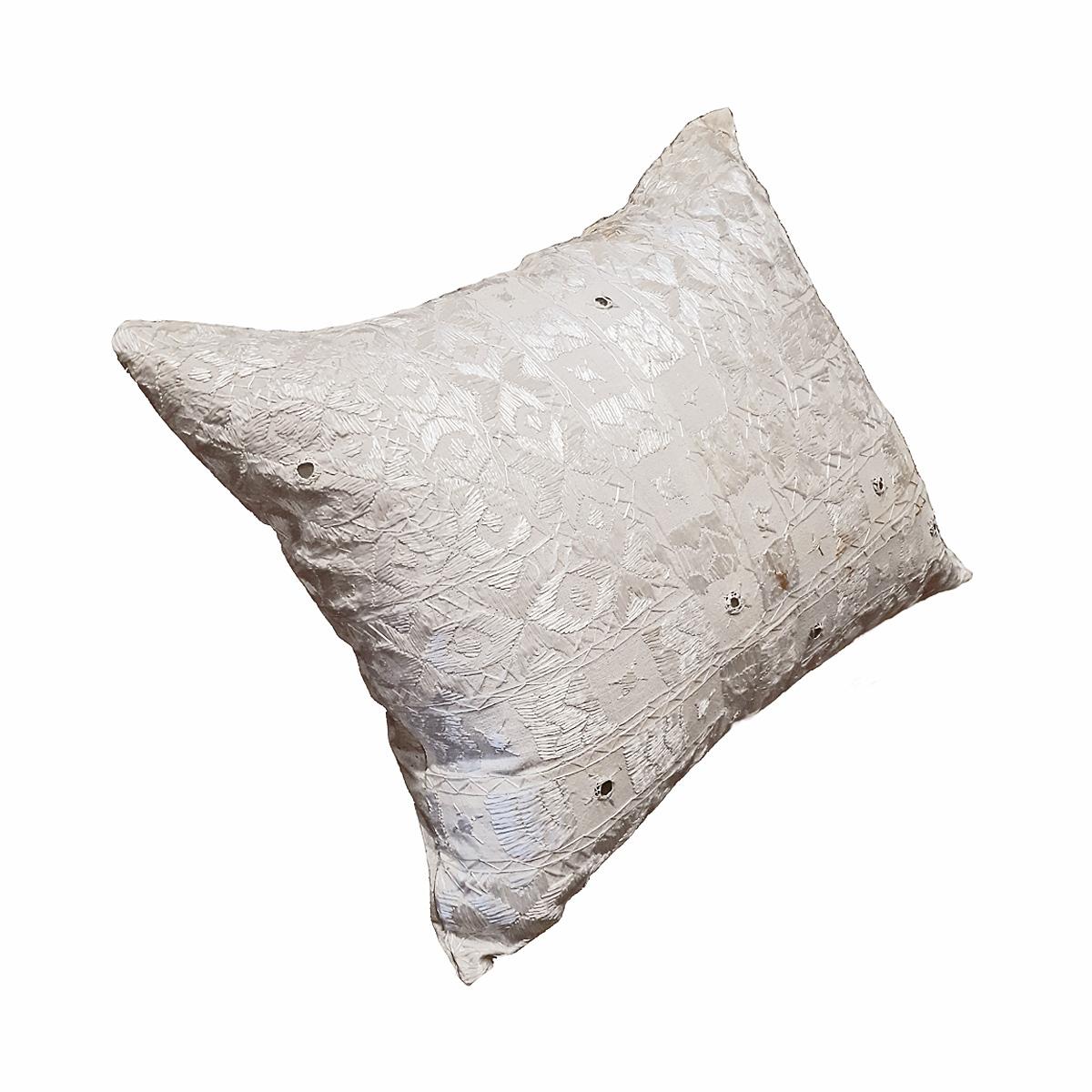 An Indian silk pillow, hand-crafted and embroidered in silk, tone on tone. 

The front is intricately embroidered with shiny silk and tiny mirrors. The back is satin silk, with square mother-of-pearl fastening buttons. 95/5 feather-down insert.