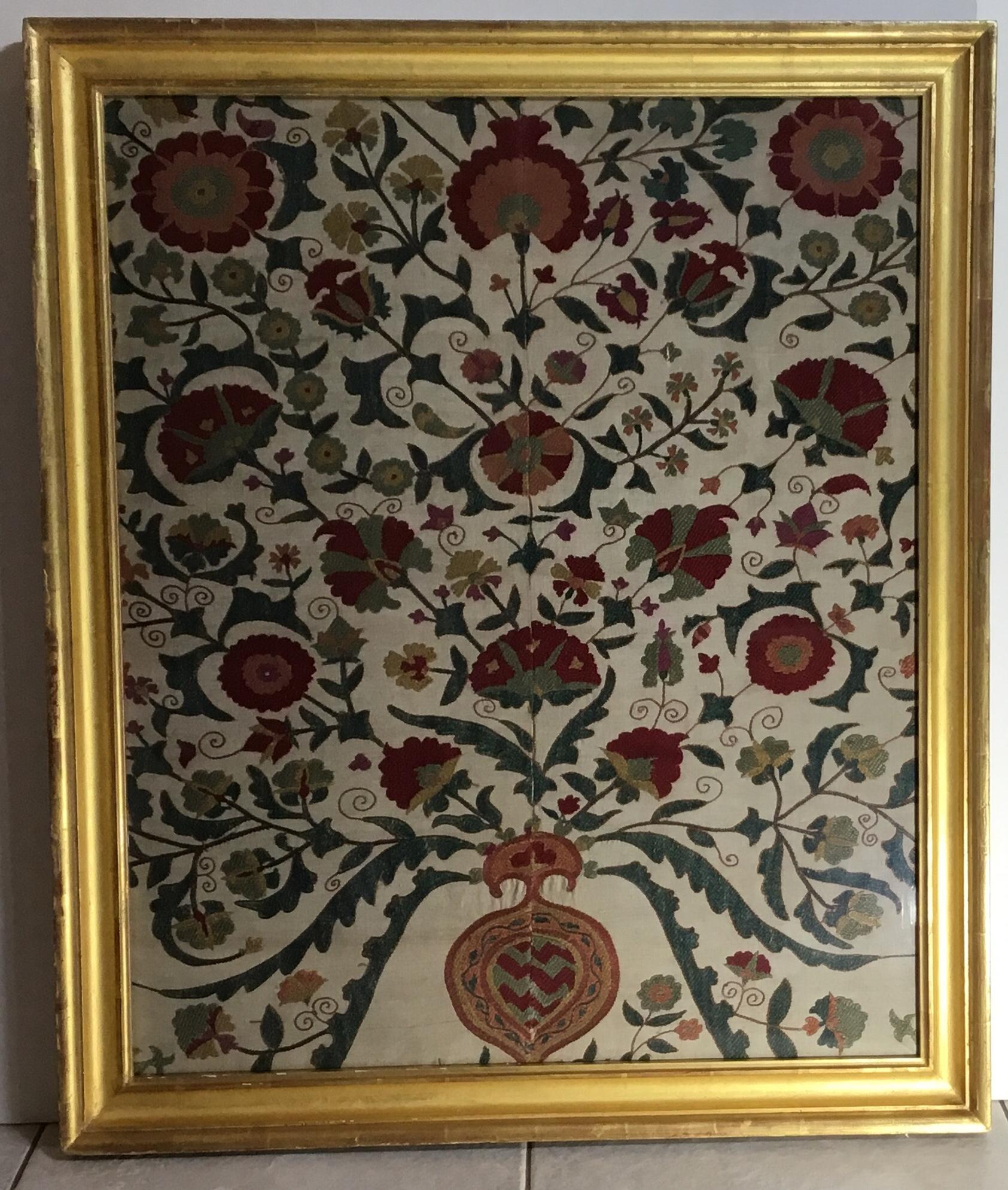 Exceptional hand embroidery suzani textile, professionally framed in antique gold leaf wood frame and protected with glass. Beautiful colorful motifs of vine and flowers make this wall hanging great decorative object of art to hang in any room.
