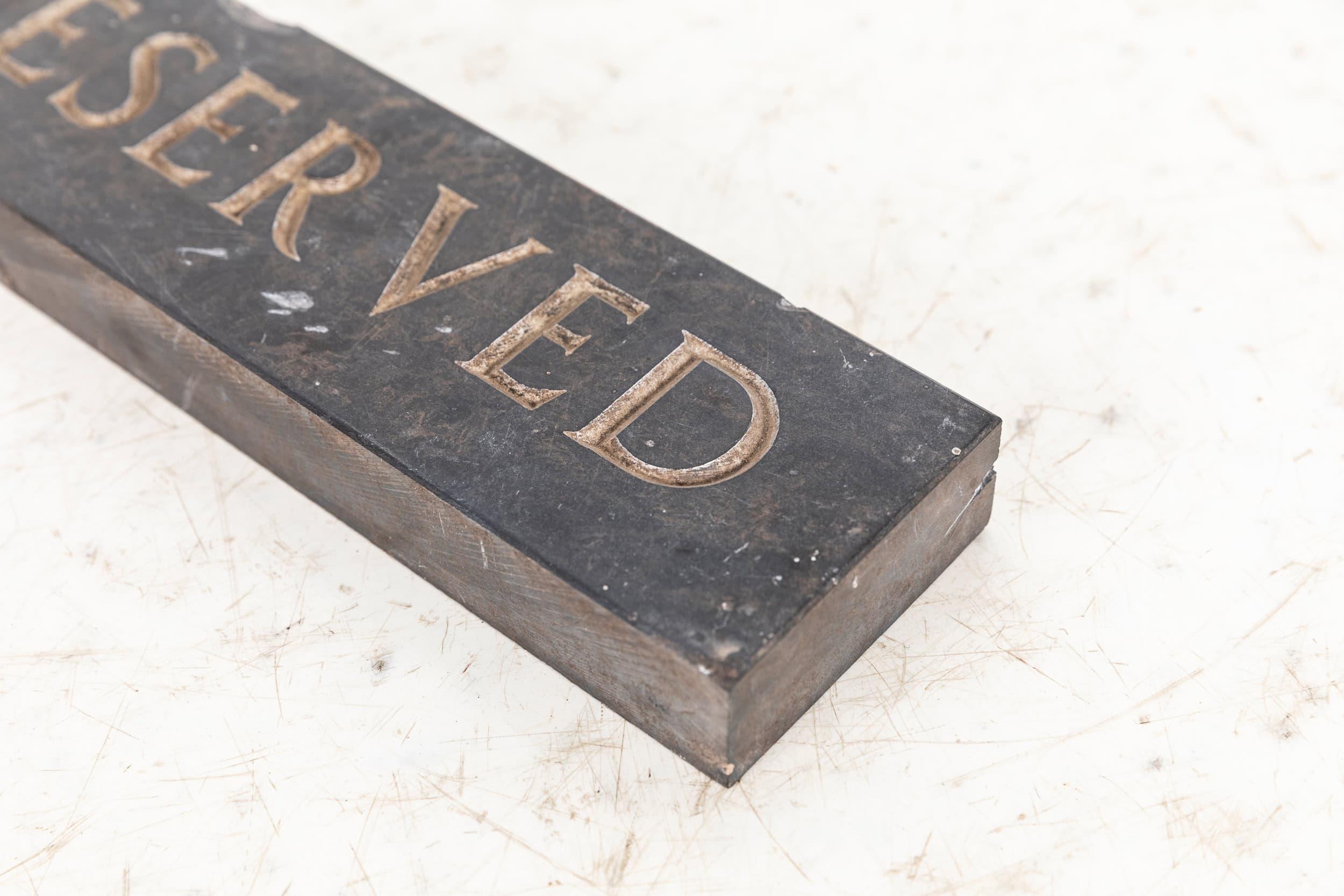 An elegant hand engraved slate reserved sign. c.1920

A thick chunk of slate, hand engraved for use as a reserved sign.