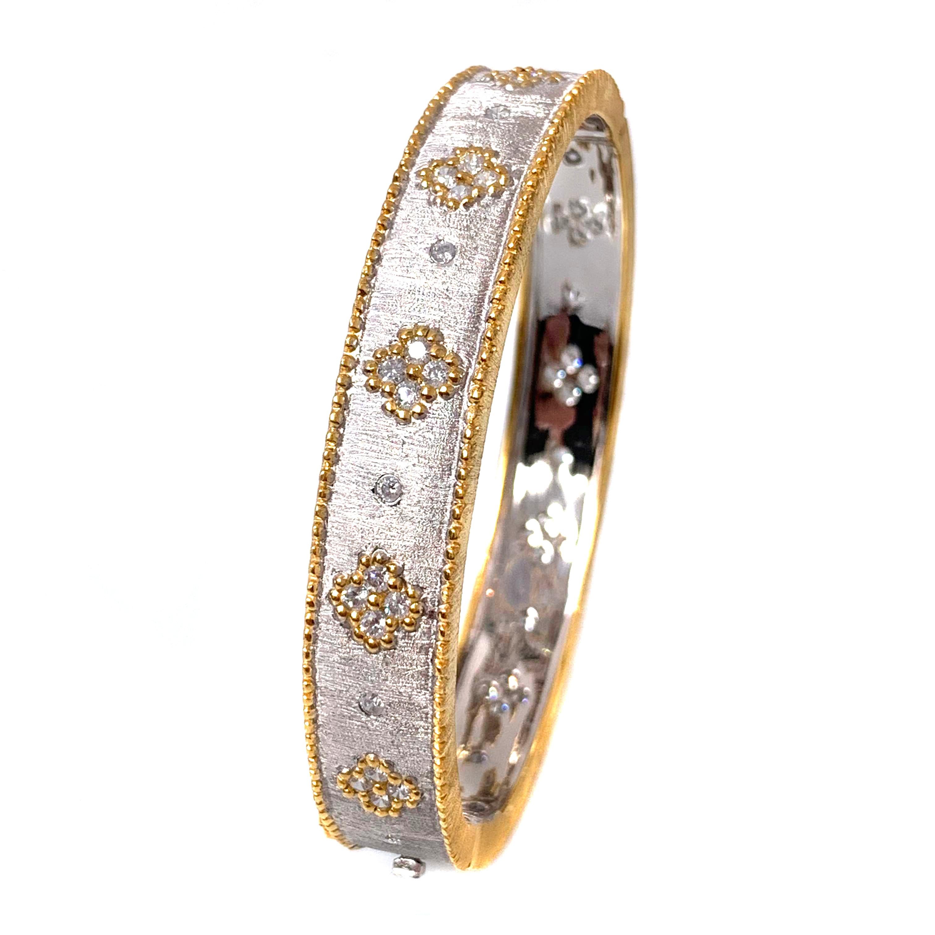 Bijoux Num hand-engraved clover pattern two-tone platinum plated bangle bracelet. 

This beautiful bracelet features over 50 pcs of round faux diamond cubic zirconia (CZ), handcrafted Italian 
