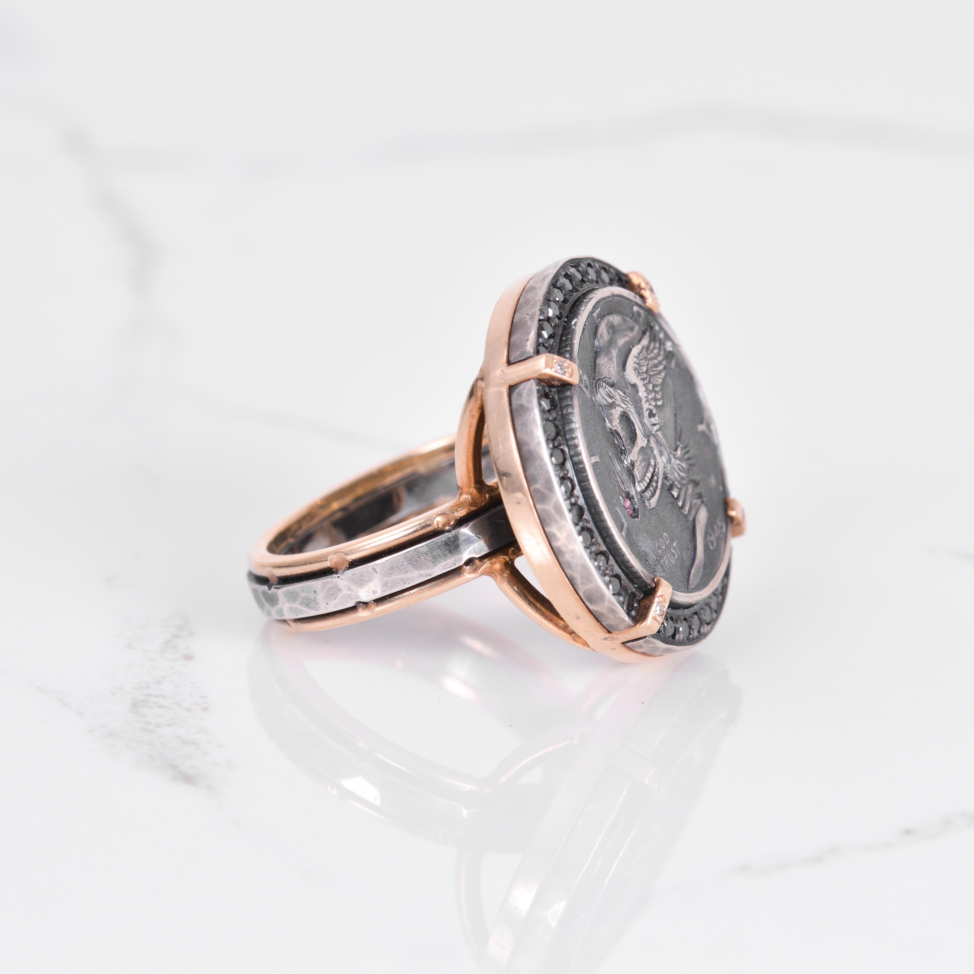 A one of a kind hand carved hobo coin with black and white diamonds, and ruby accent, all set in silver and 14k yellow gold. The dimension of the ring is 22mm in diameter. Ring size is a 7.

Additional sizes available upon request. 